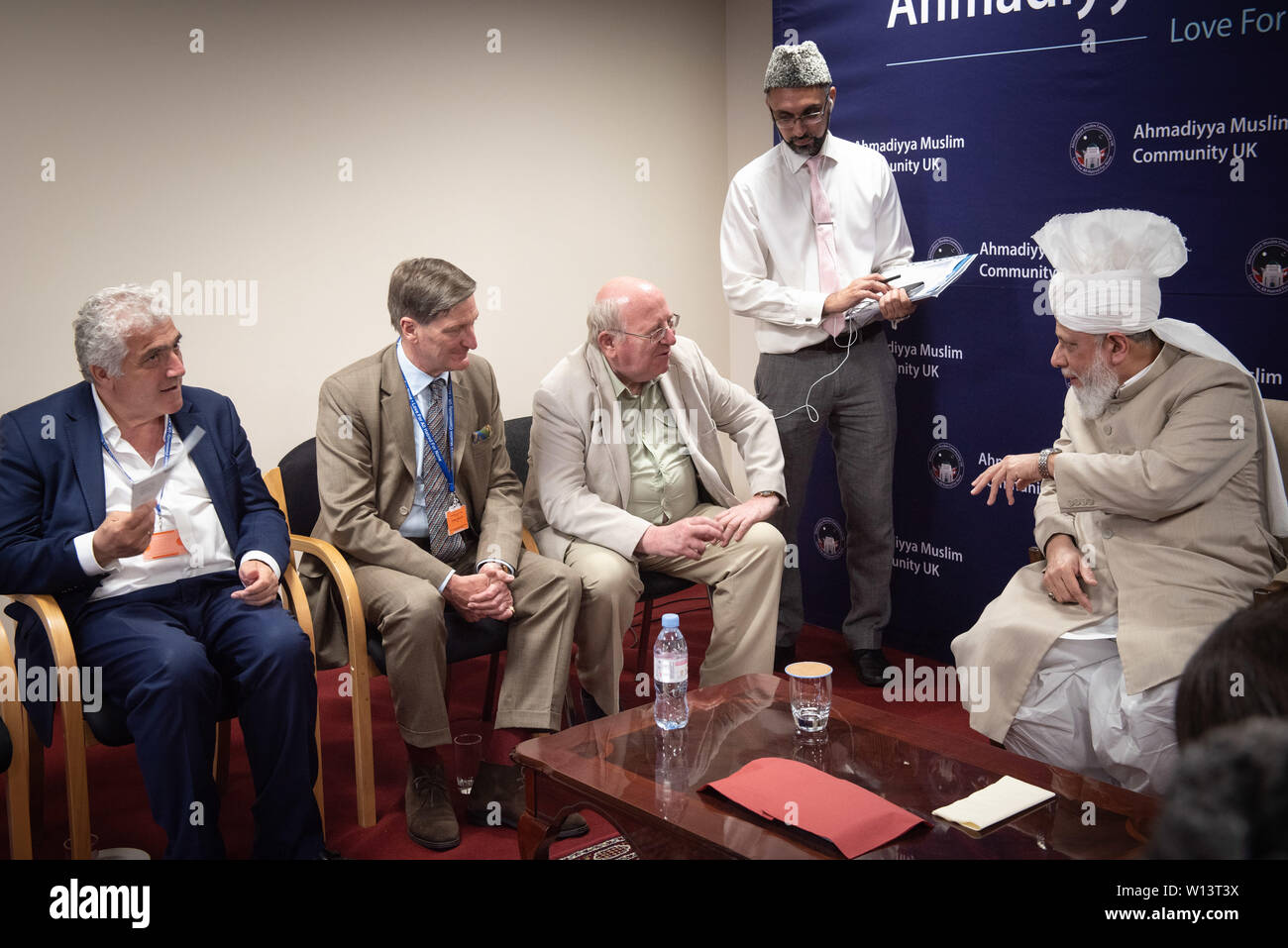 Mubarak Mosque, Sheephatch Lane, Tilford, Surrey, UK. 29th June 2019. Pictured seated L-R: Cllr Stephen Alambritis - Leader of Merton Council;  Rt Hon Dominic Grieve QC MP; Mike Gapes MP; His Holiness Hazrat Mirza Masroor Ahmad. / Hundreds of muslims together with Members of Parliament, Secretaries of State and leaders of various faiths attend the inauguration of the Mubarak Mosque in the Surrey countryside, the new home for the international headquarters of the Ahmadiyya Muslim Community. Credit: Lee Thomas/Alamy Live News Stock Photo