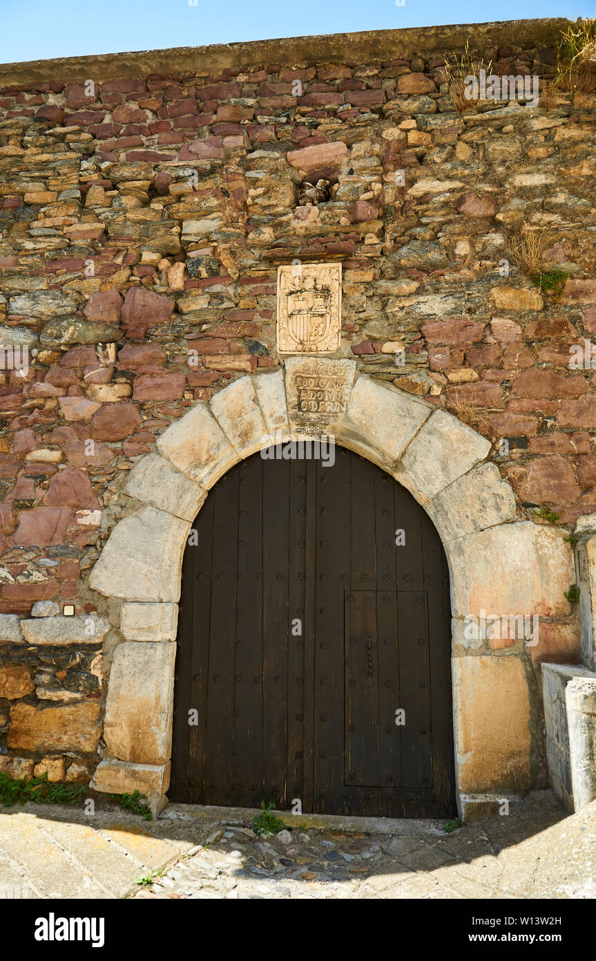 Wood door with stone frame and lintel with coat of arms of the XVI century Casa Rins house in Gistaín (Chistau valley, Sobrarbe, Huesca, Aragon,Spain) Stock Photo