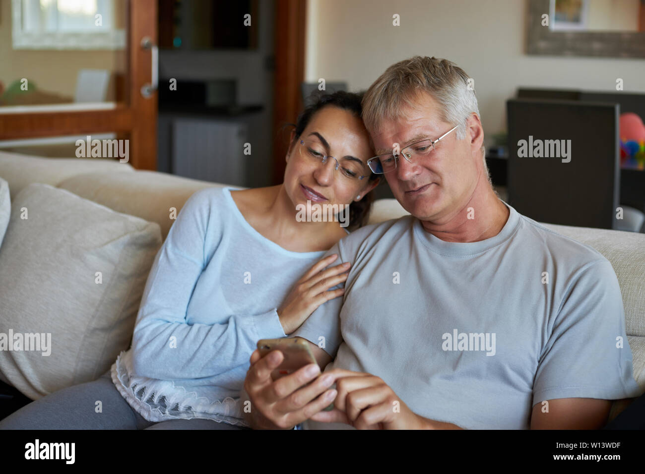Middle-aged couple looking a mobile phone Stock Photo