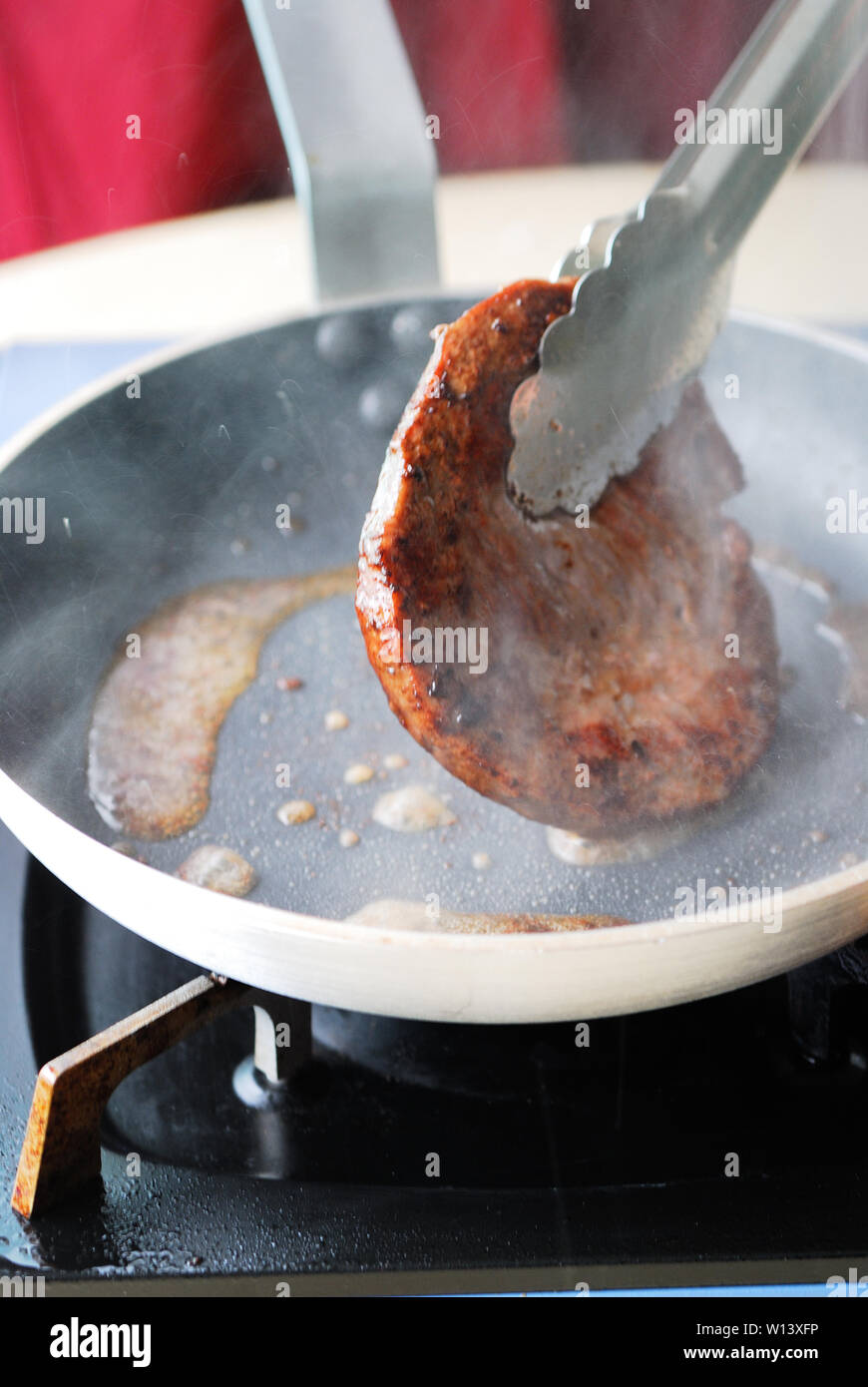 Fry the steak in a pan Stock Photo Alamy