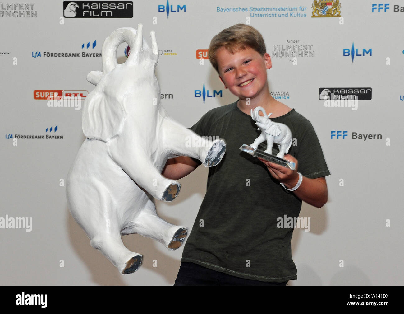 Munich, Germany. 30th June, 2019. The actor Julius Weckauf is delighted  about his trophy at the presentation of the children's media prize "The  white elephant" at the Munich Film Festival. The prizewinner