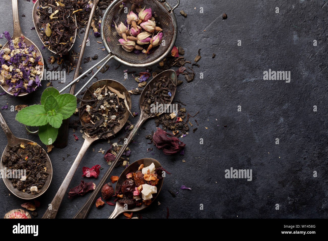 Dry Tea Mix of different herbal and fruit dry teas on stone background. Top ...