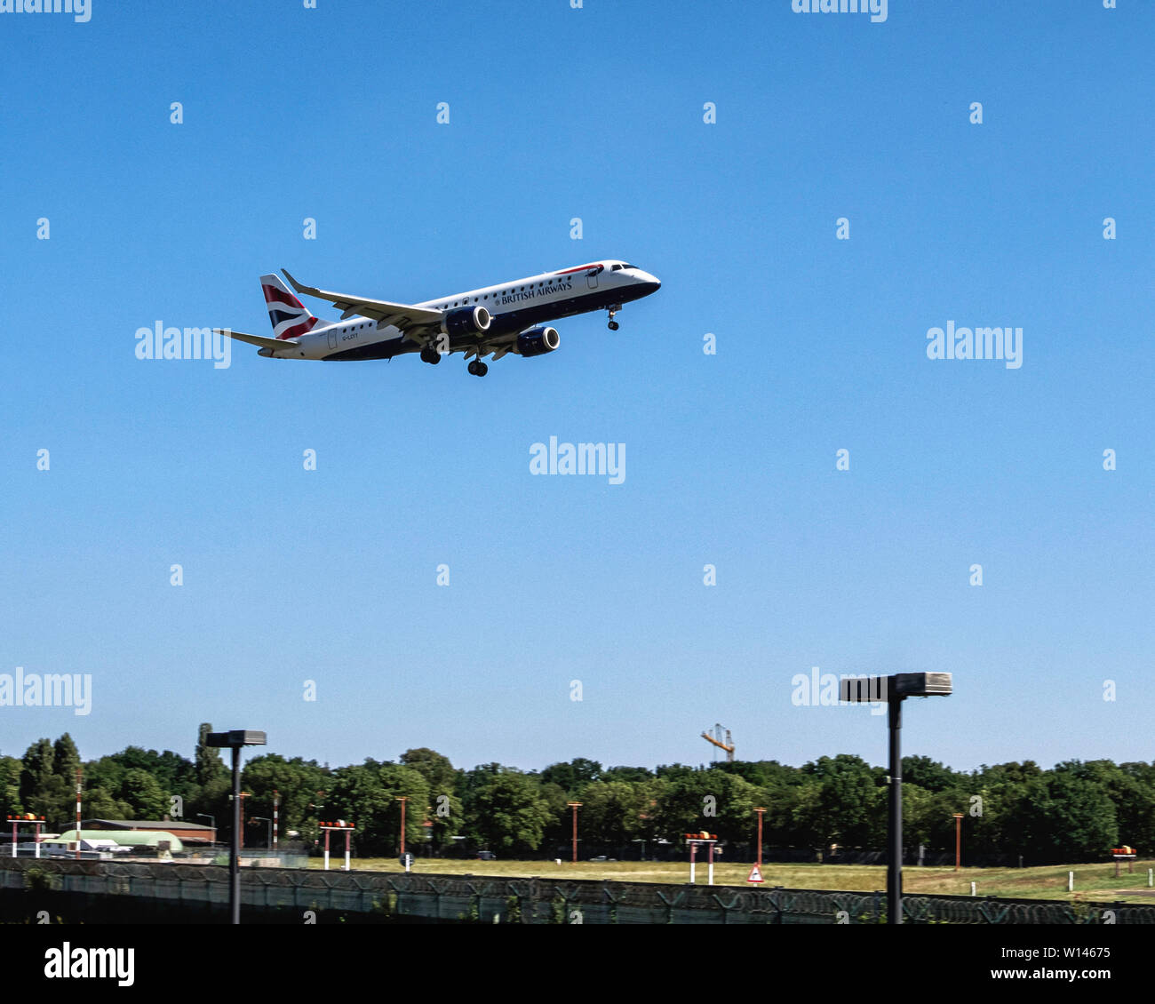 British Airways Plane in the air. Aeroplane approaching Tegel airport & coming in to land, Berlin Stock Photo