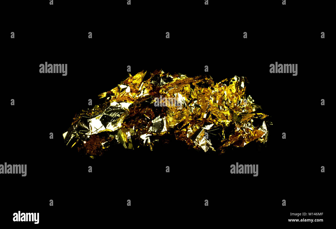 Scraps gold foil and empty space on black background Stock Photo