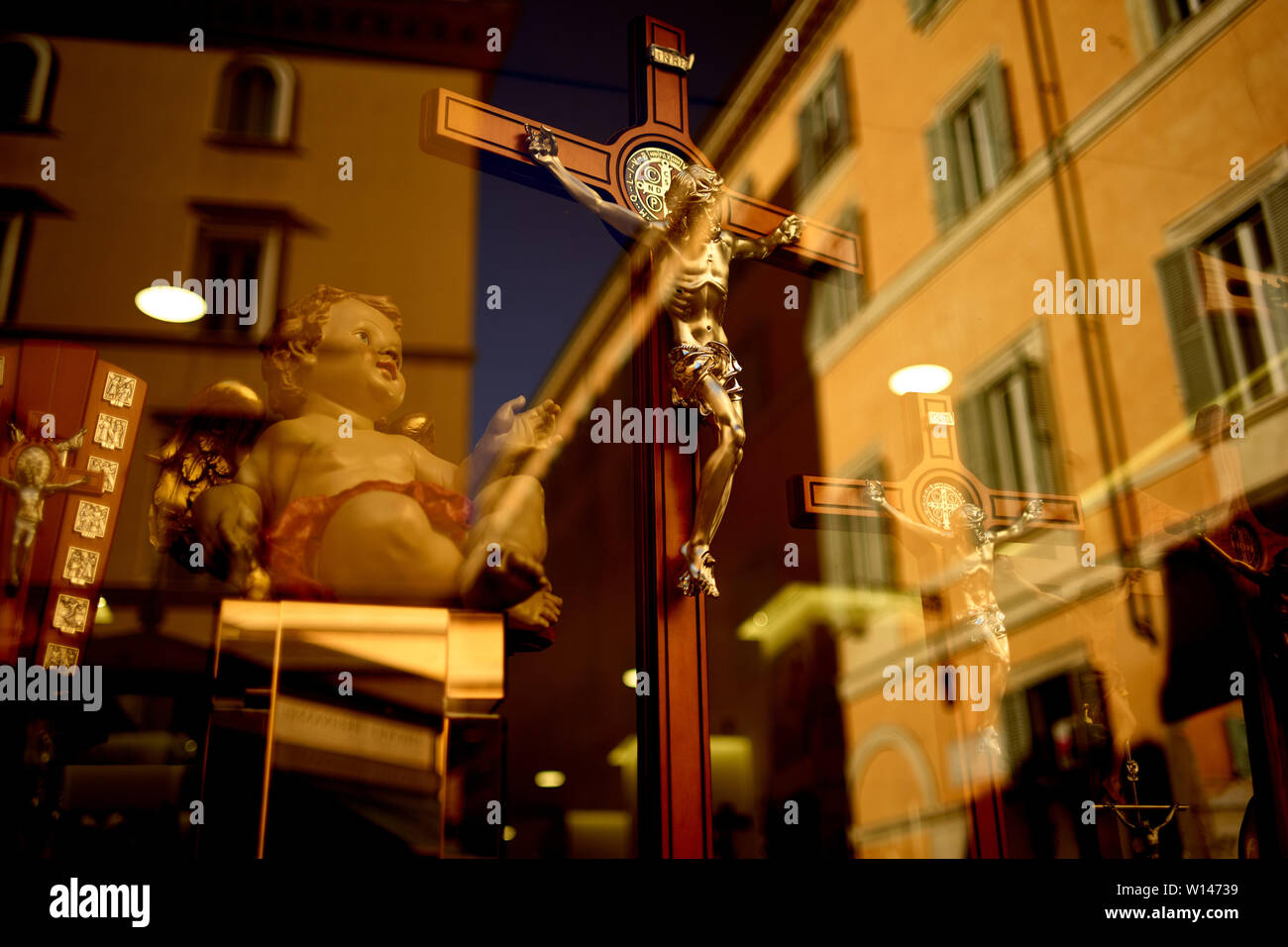 Religious artifacts on display in the window of a shop in Rome, Italy
