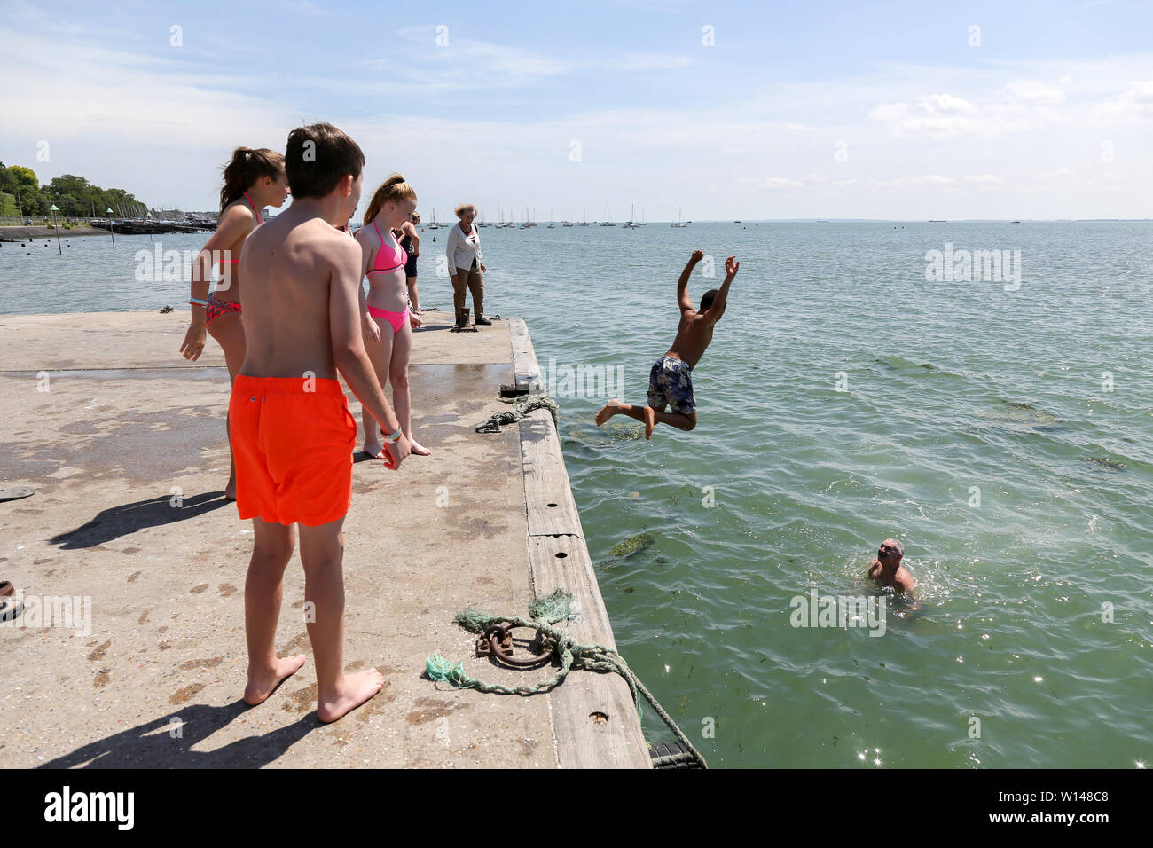 leigh on sea uk 30th june 2019 people jump into the high tide to cool down hot weather in old leigh essex penelope barritt alamy live news stock photo alamy