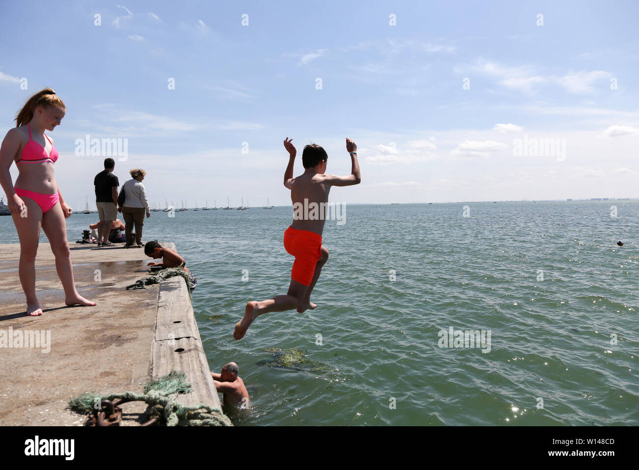 leigh on sea uk 30th june 2019 people jump into the high tide to cool down hot weather in old leigh essex penelope barritt alamy live news stock photo alamy