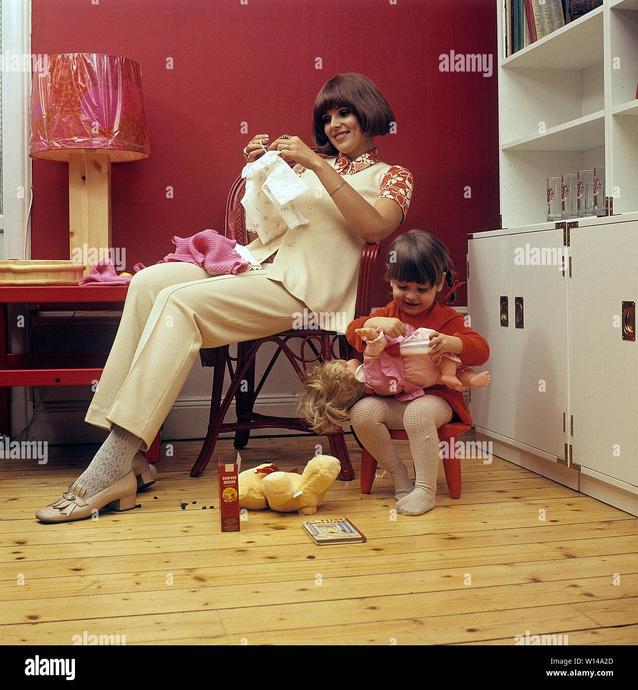 1960s mother. A young woman with her daughter are playing together with her doll. Sweden 1964 Stock Photo