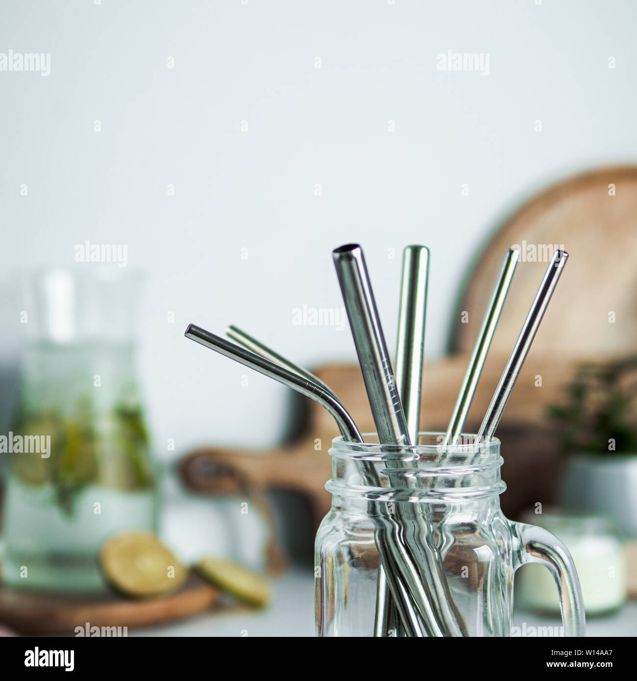 Metal drinking straws in glass mason jar indoor. Metal straws on table on  kitchen table. Recyclable straws, zero waste concept Stock Photo - Alamy