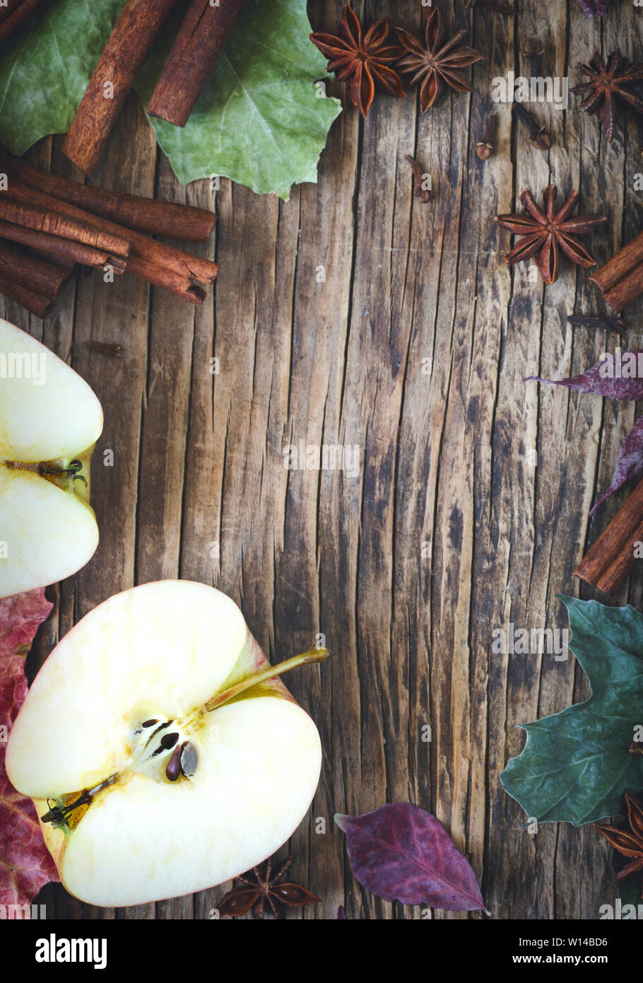 Autumn frame wth apple, cinnamon stick, star anise and clove, copy space, top view Stock Photo