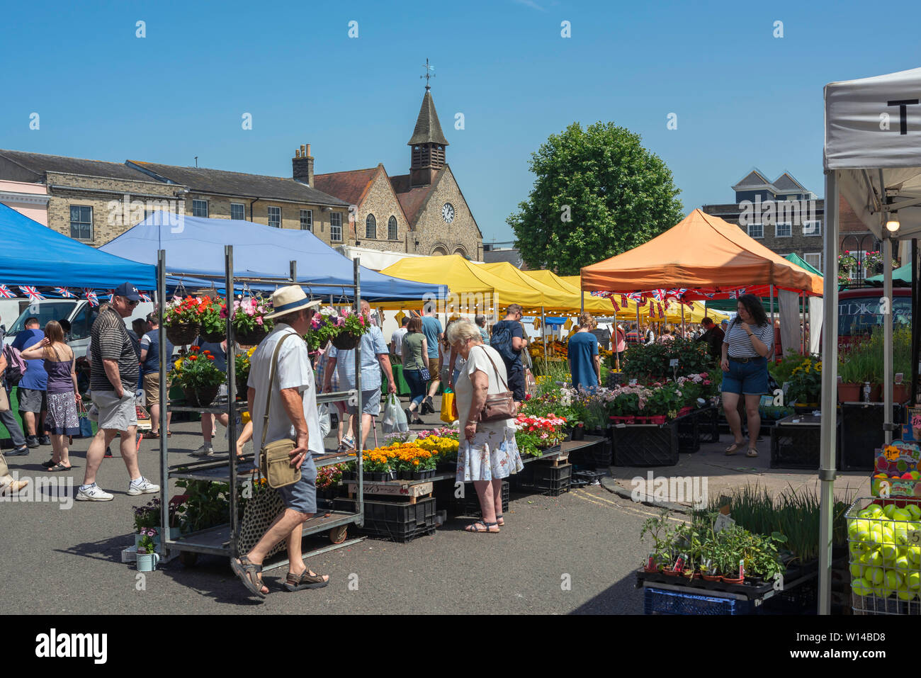 Bury St Edmunds market, view in summer of people shopping in the Saturday market in the centre of Bury St Edmunds, Suffolk, East Anglia, UK. Stock Photo