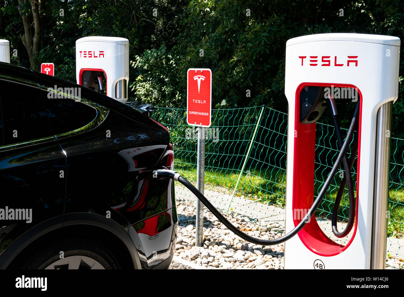 Maienfeld, GR / Switzerland - 30 June, 2019: Tesla Super Charging Station in Maienfeld allowing free charging of all Tesla cars within an hour Stock Photo