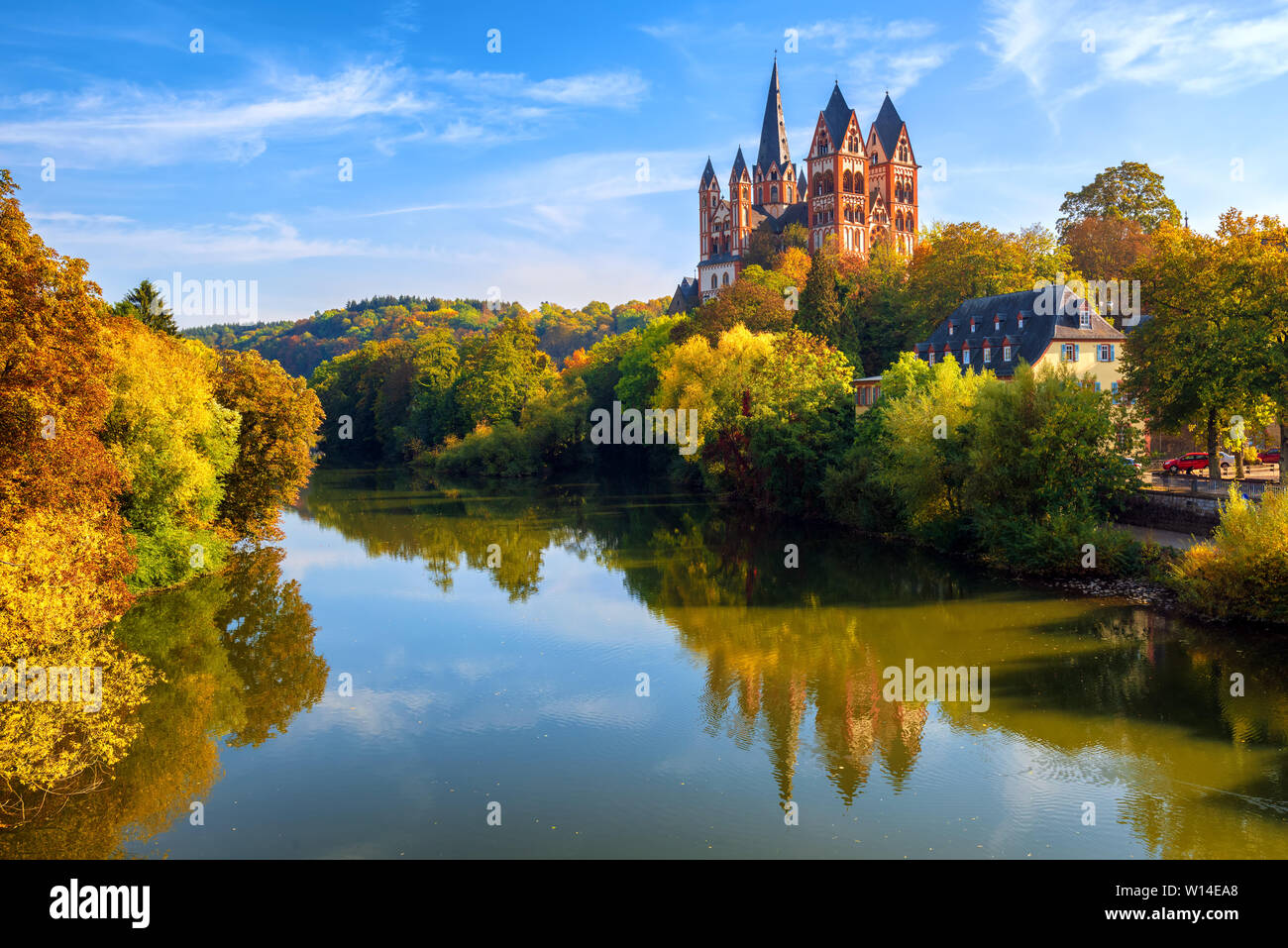 Limburg an der Lahn town, Germany, view of the cathedral reflecting in Lahn river in autumn Stock Photo