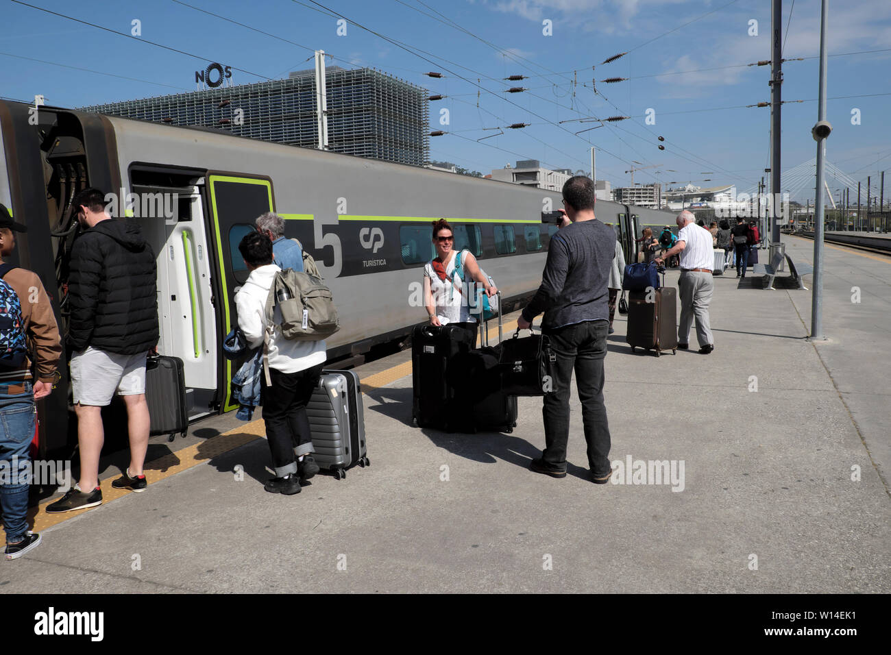 Passengers & luggage boarding the Alfa Pendular high speed train to travel from Campanha station Porto to Lisbon city in Portugal Europe  KATHY DEWITT Stock Photo