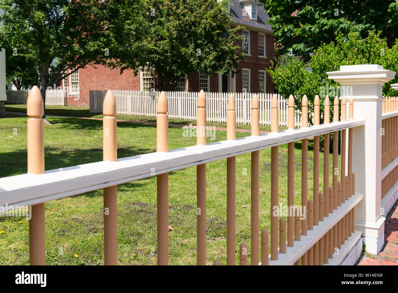 Wooden picket fence in front of historic home. Stock Photo