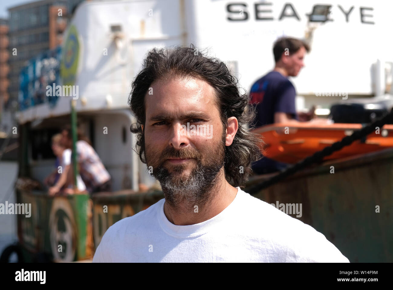 30 June 2019, Hamburg: Michael Buschheuer, founder of the organization Sea-Eye, stands in front of the rescue ship 'Sea-Eye' in the harbour. The Regensburg aid organization Sea-Eye wants to bring its decommissioned rescue ship of the same name to the museum in Hamburg. Photo: Daniel Bockwoldt/dpa Stock Photo