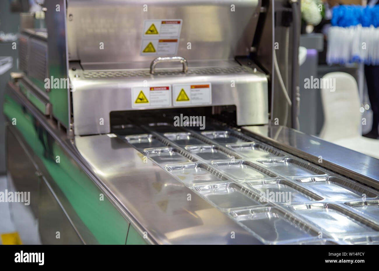 Linear tray food heat sealing and packaging machine Stock Photo Alamy