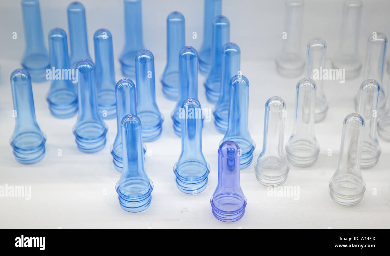Raw material for plastic bottle blowing machine Stock Photo - Alamy