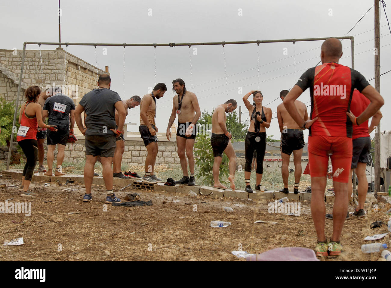 Batroun, Lebanon. 30th June, 2019. Participants take a shower after the end  of the 6th Puma Hannibal Race, an annual 8-kilometer obstacle race at Zen  Batroun that includes more than 900 participants