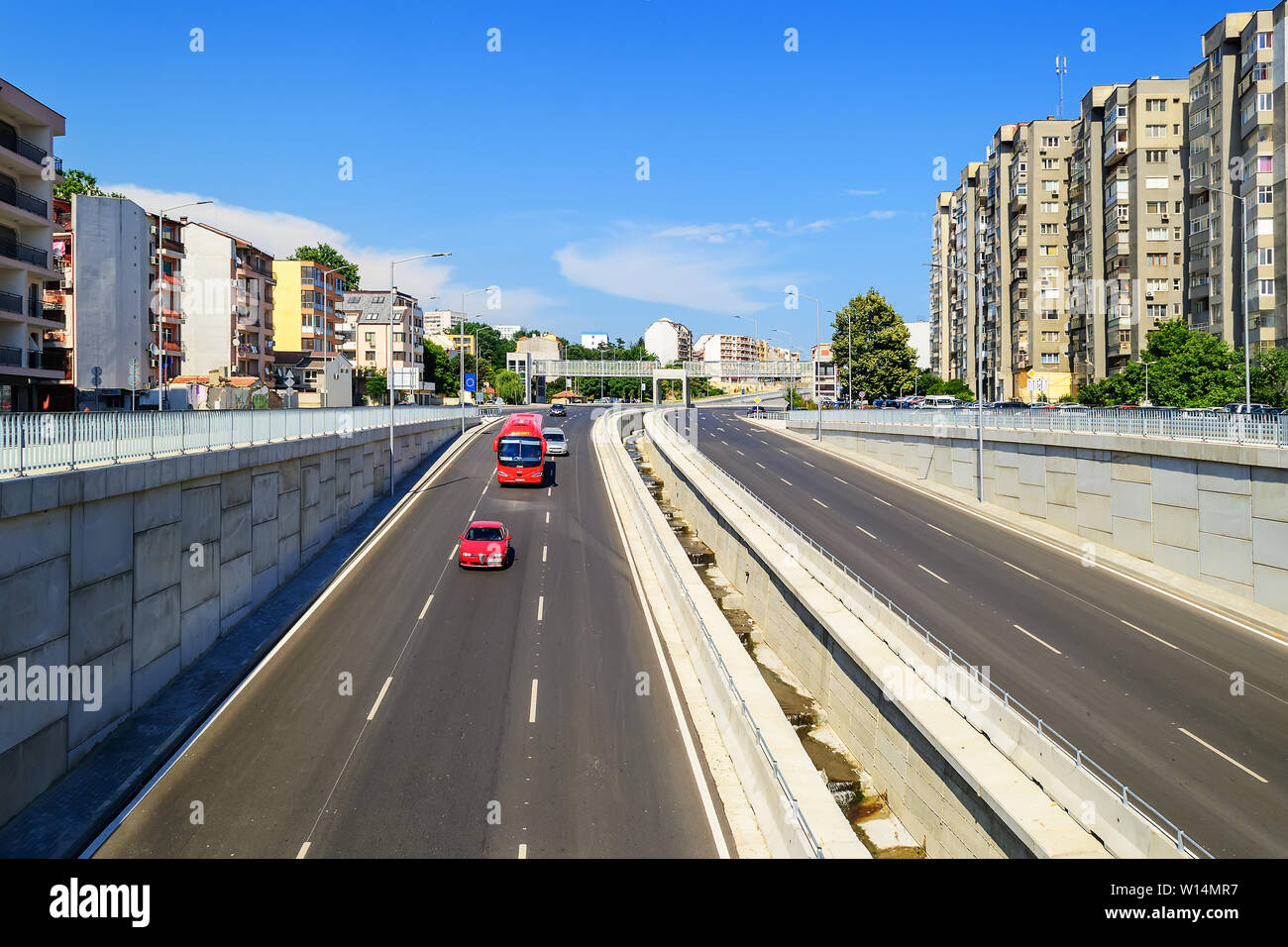 Varna, Bulgaria, June 23, 2019. New six lane asphalt road with storm sewer preventing flooding the road under the bridge. Cityscape and transportation Stock Photo