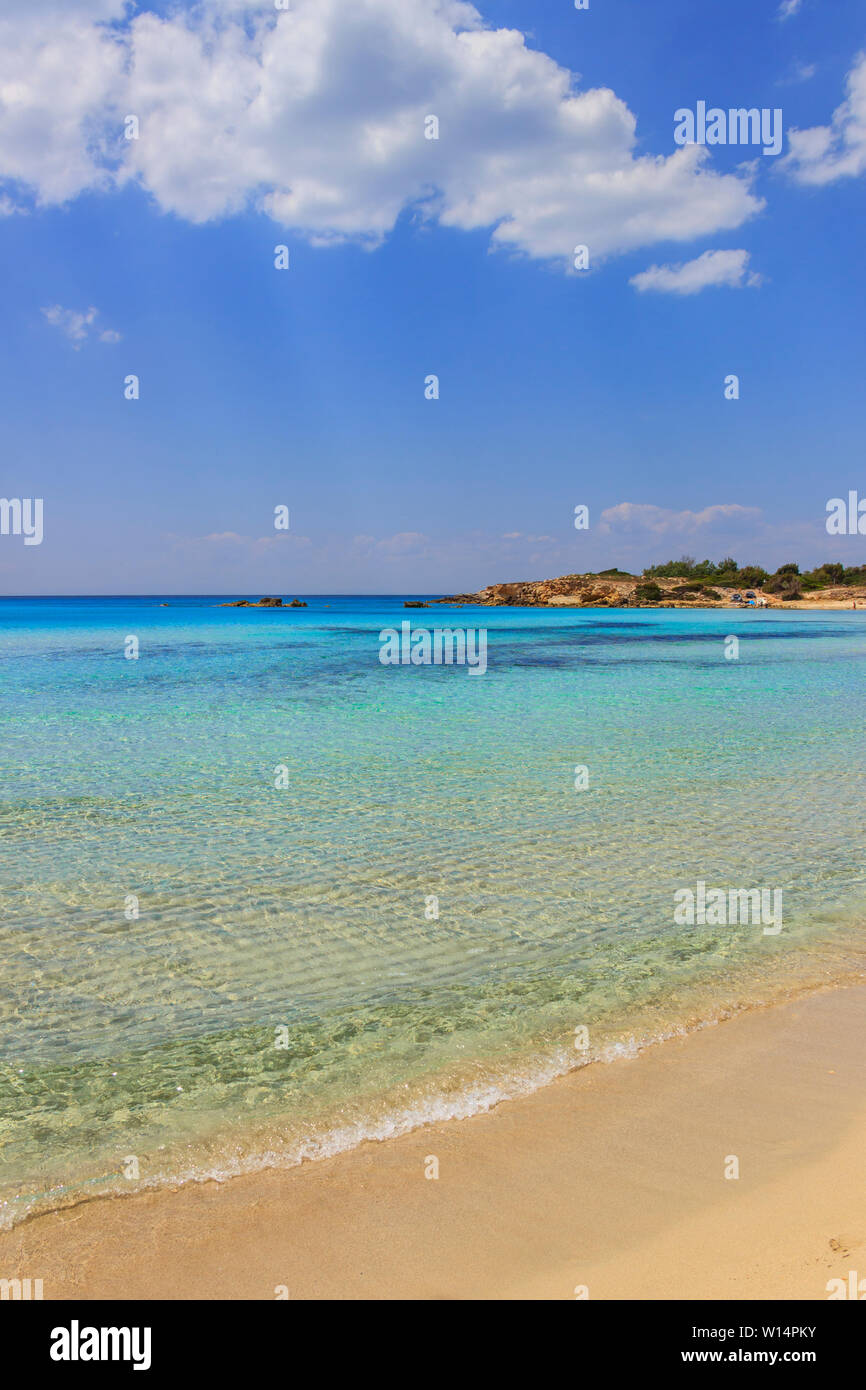Summertime: Marina di Pulsano beach.The Apulia coastline is characterized by a alternation of sandy coves and jagged cliffs overlooking a truly clear. Stock Photo