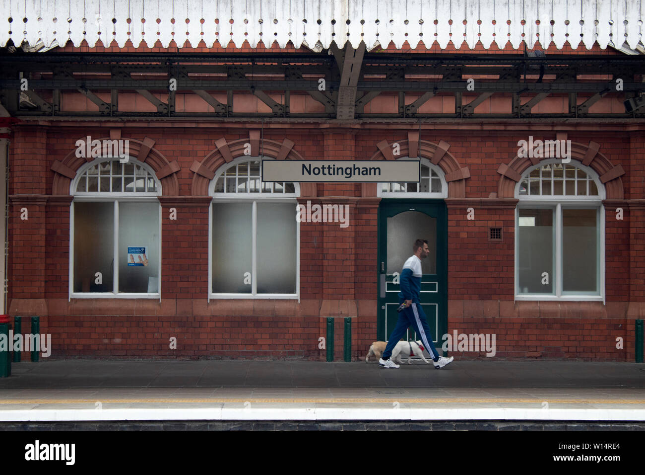 A passenger hurrying along a platform inside Nottingham railway station Nottinghamshire, East Midlands England UK Stock Photo