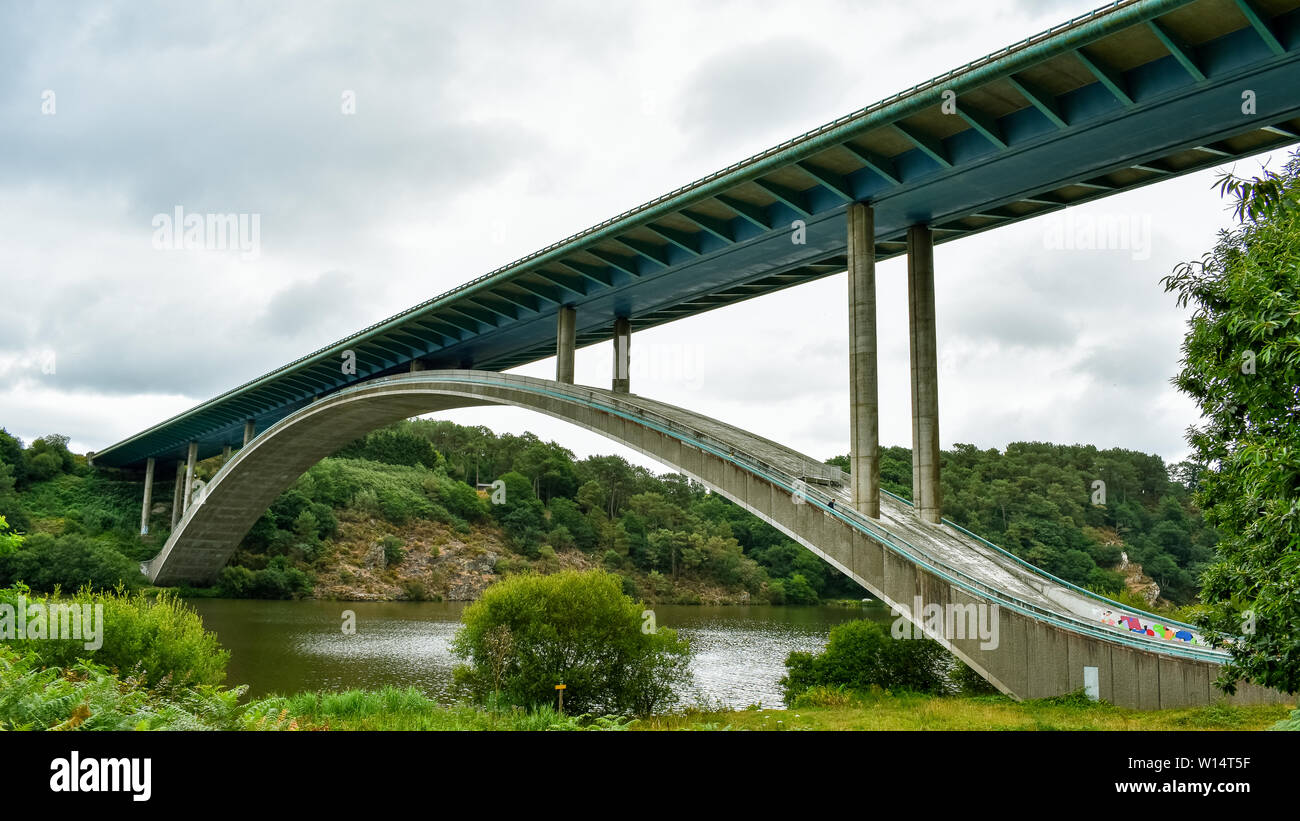 Motorway bridge over the river, in a green landscape. Stock Photo