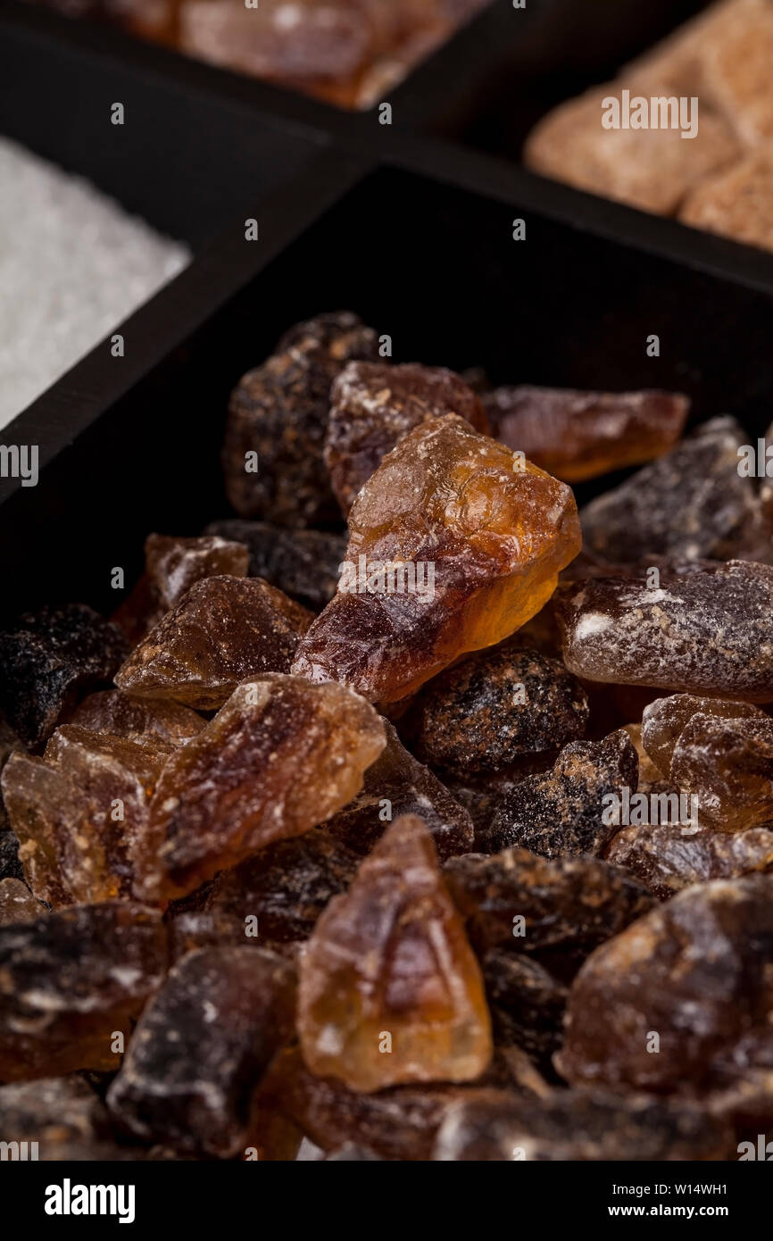 Various kinds of sugar in a wooden box. White refined, brown cane sugar collection Stock Photo