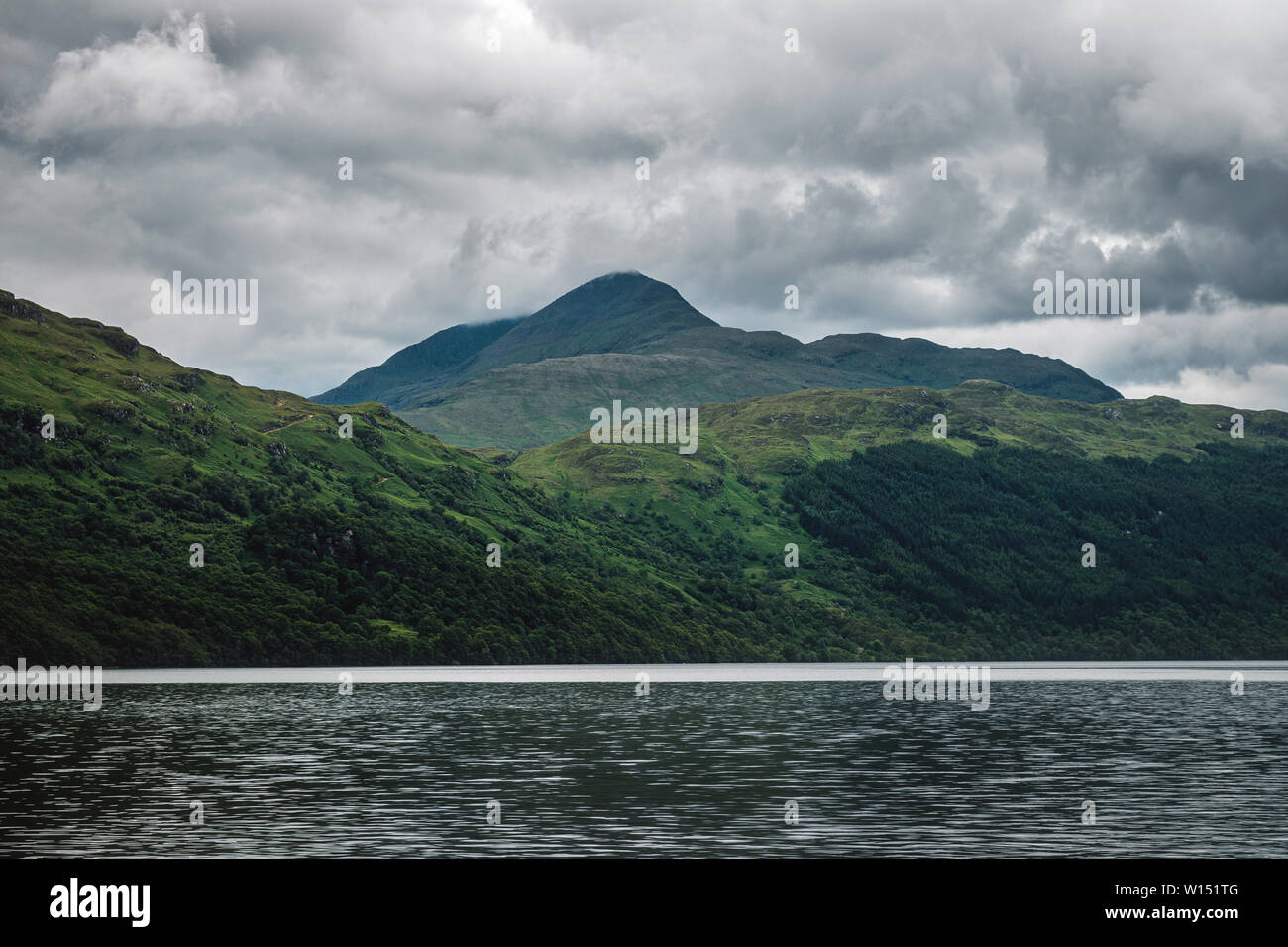 Scottish landscape with lake view and clouds covered green mountains. Summer 2019. Loch Lomond, Scotland Stock Photo