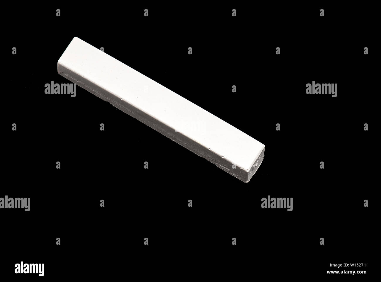 White Chalk isolated on Black Background Stock Photo