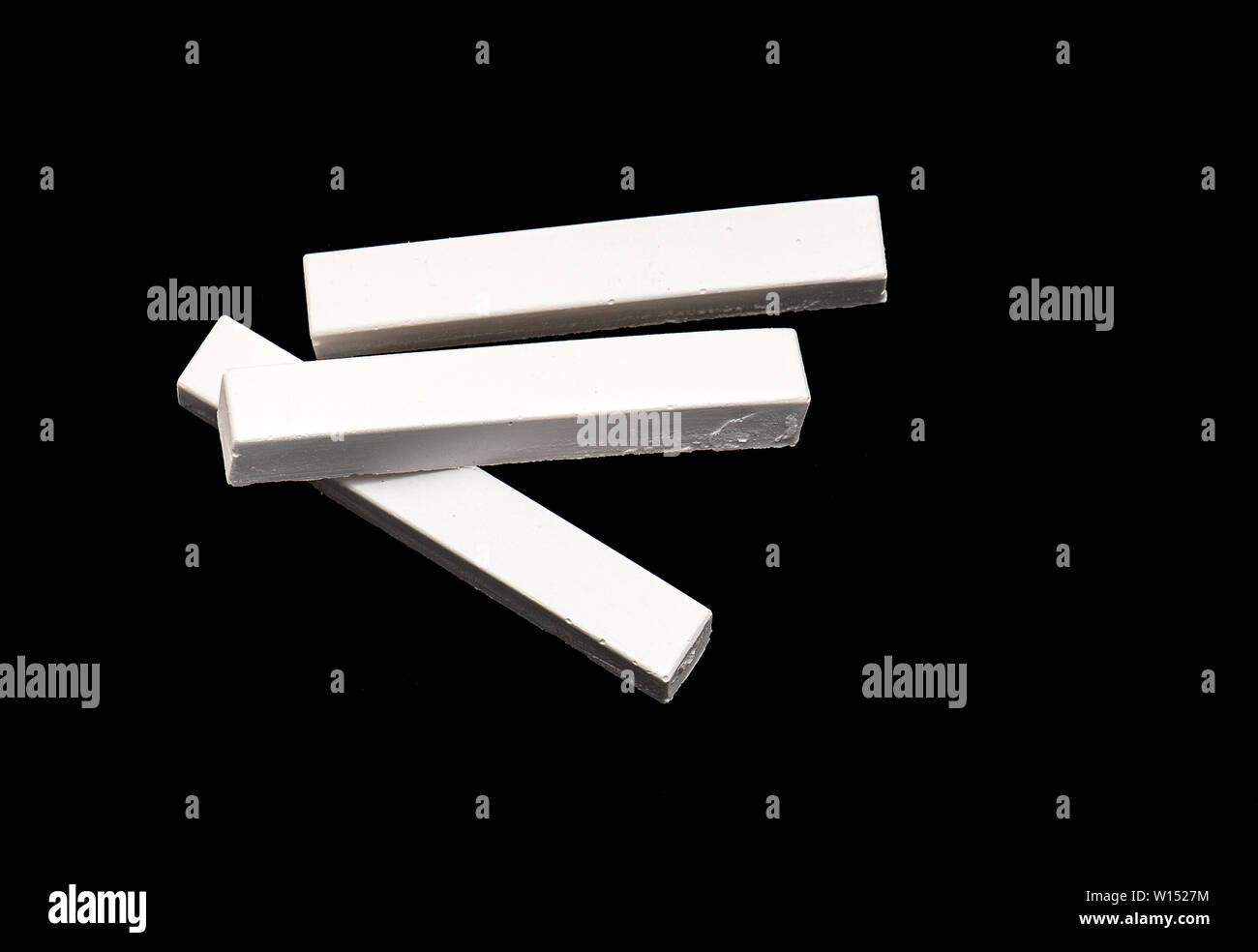 White Chalk isolated on Black Background Stock Photo