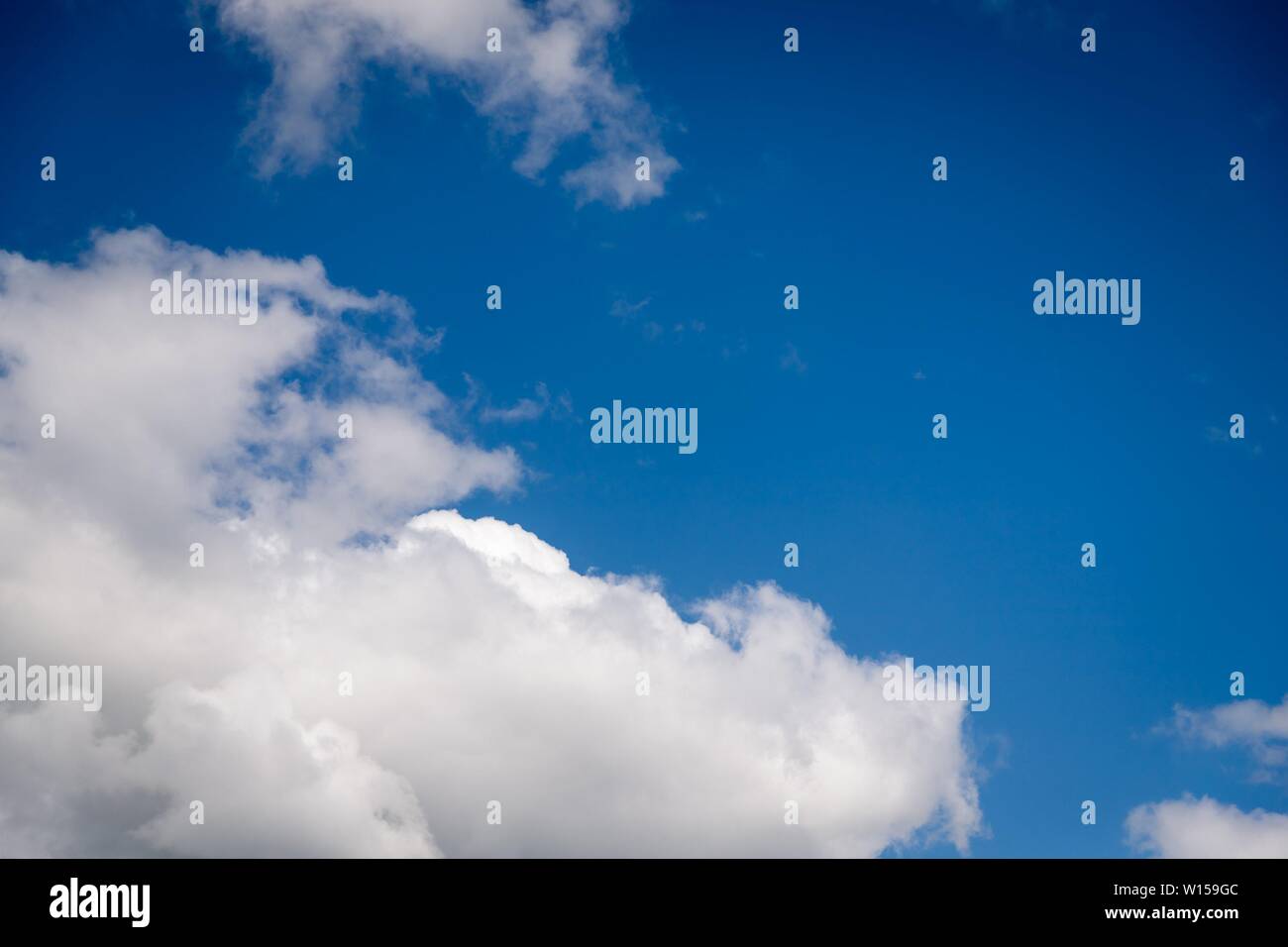 Beautiful white fluffy clouds on a deep blue sky background. Scenic sky ...