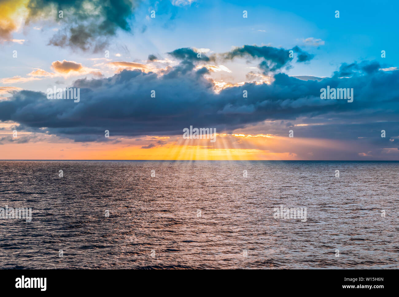 Cloudscape with sunset and sunbeam over the sea, Guadeloupe, Caribbean. Stock Photo