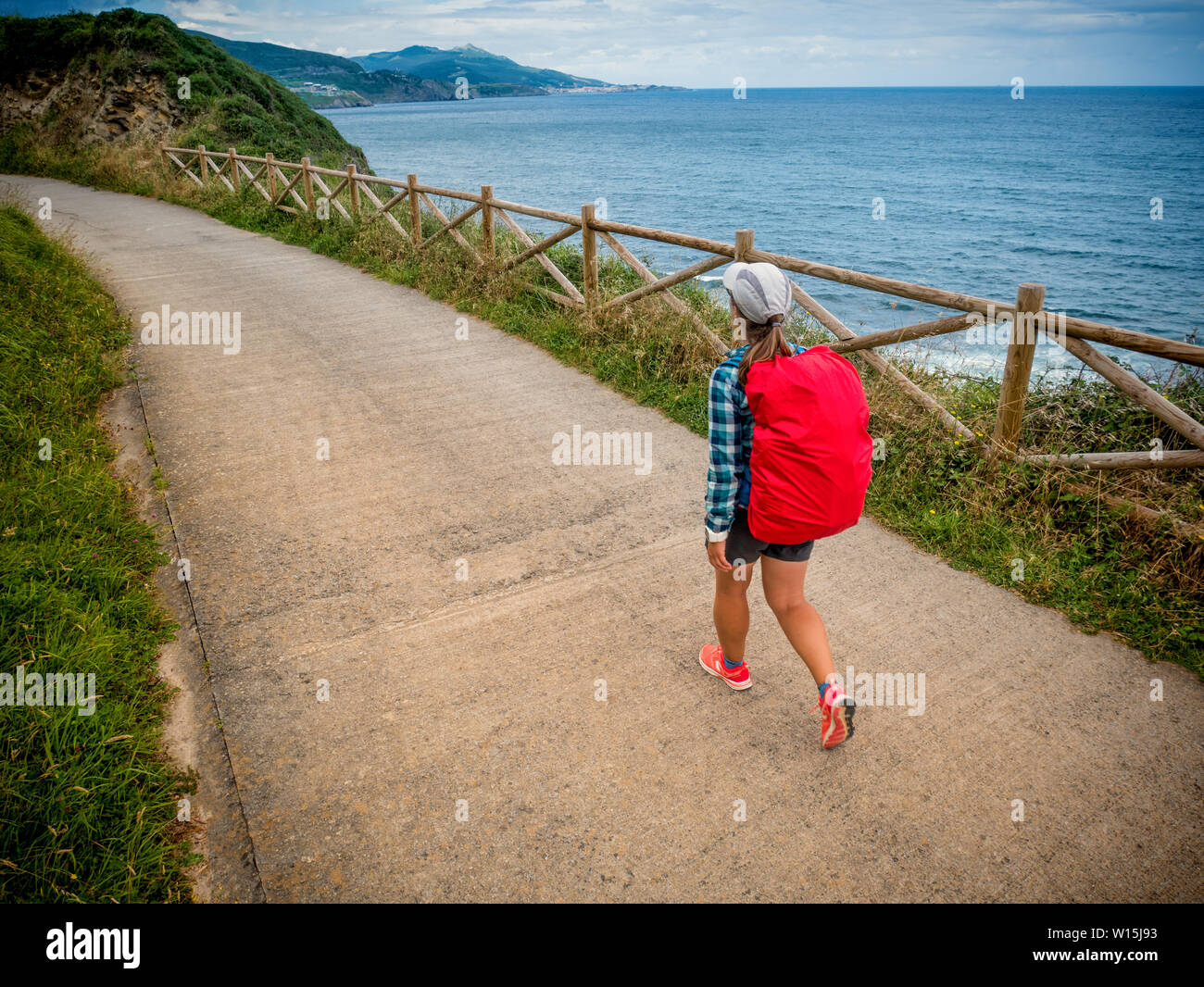 Lonely Pilgrim with backpack walking the Camino de Santiago in Spain, Way of St James Stock Photo