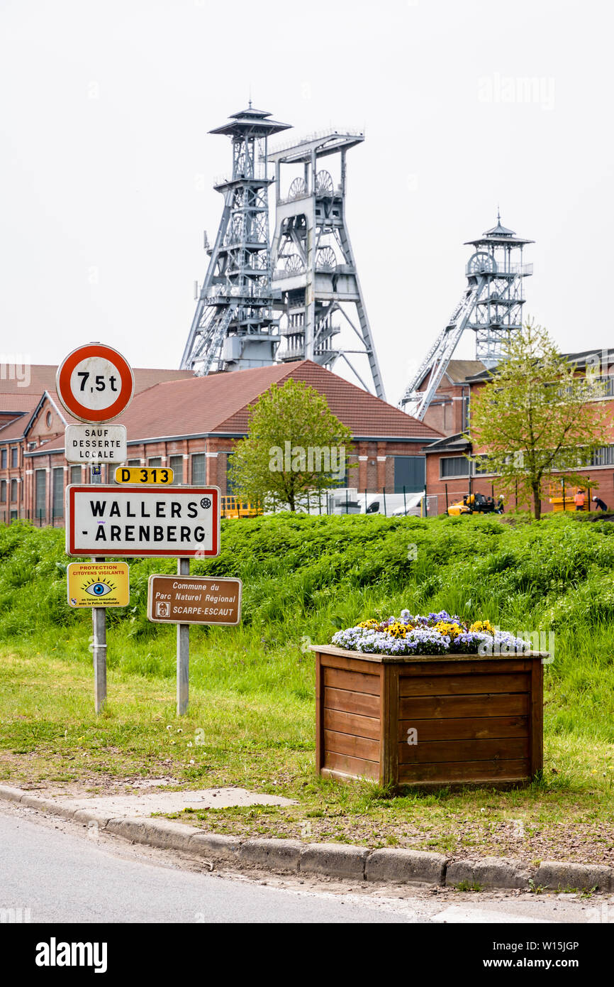 The former Arenberg mine site in Wallers in the mining basin of Nord-Pas de Calais, France, with the town sign in the foreground. Stock Photo