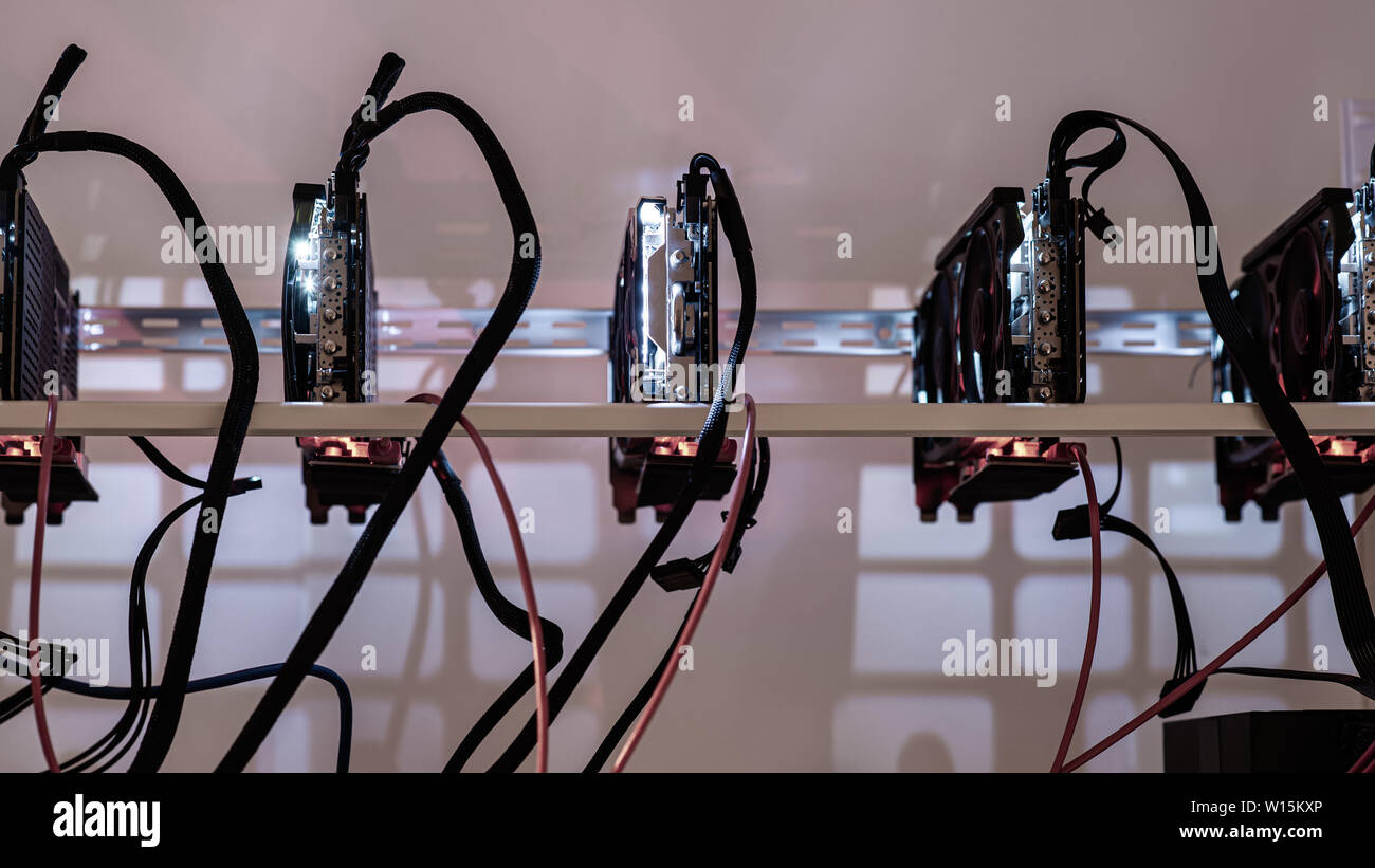 Five crypto currency graphic cards mining rig in a conceptual image of modern technology. Stock Photo