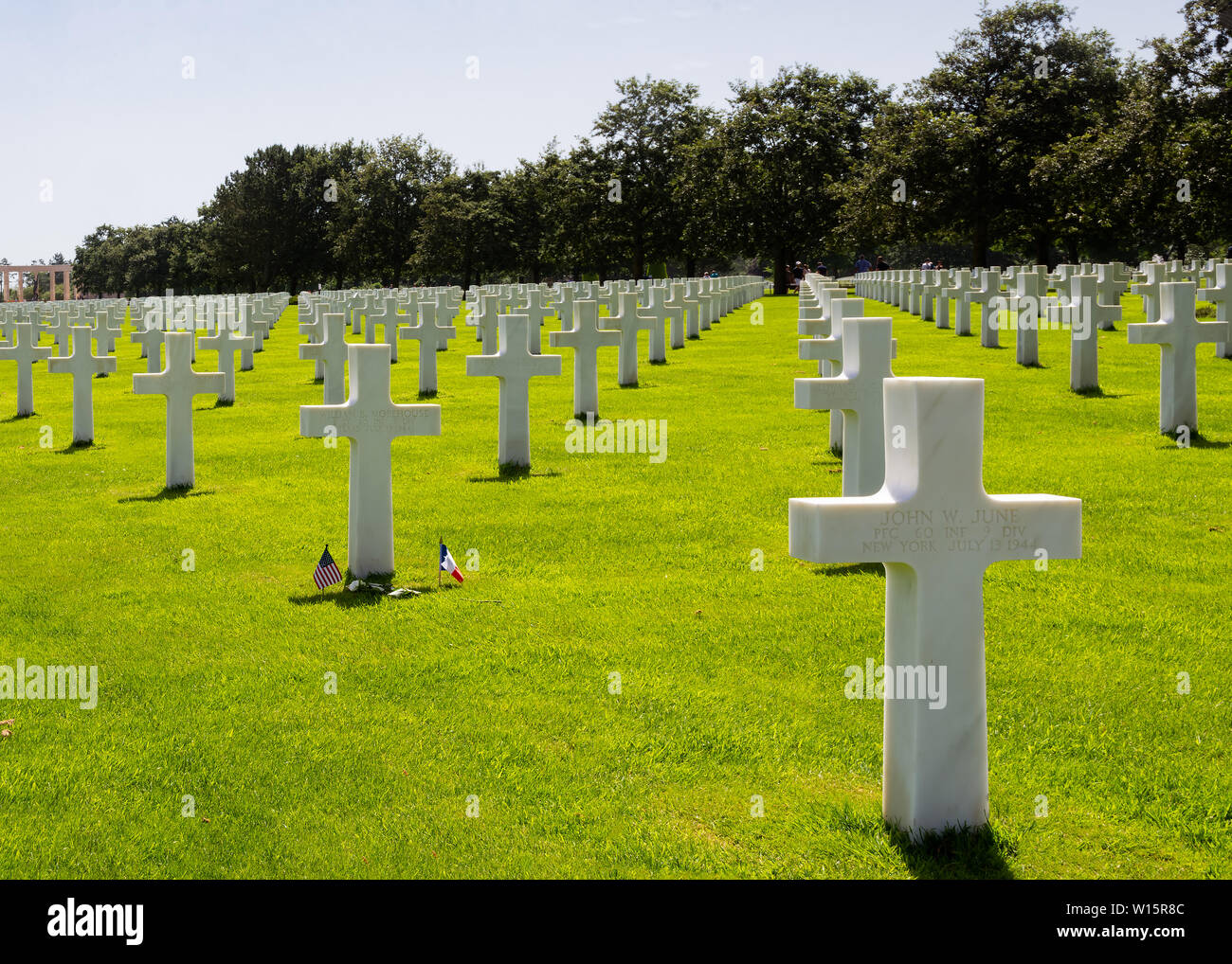 American and French flags in the middle of the graves of American soldiers who fell during the Battle of France in Normandy Stock Photo