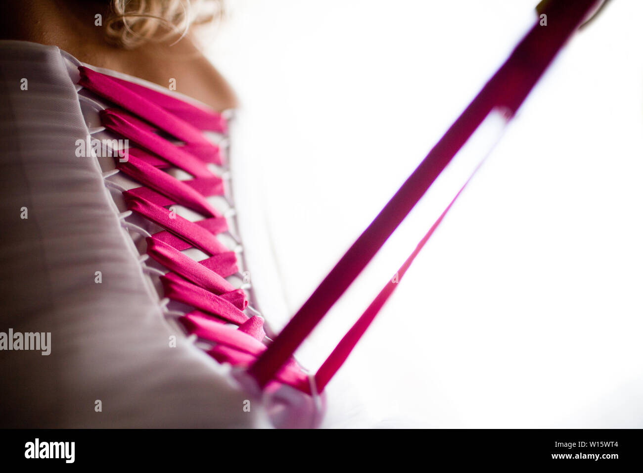 Bride from the back. Lacing the wedding dress Stock Photo - Alamy