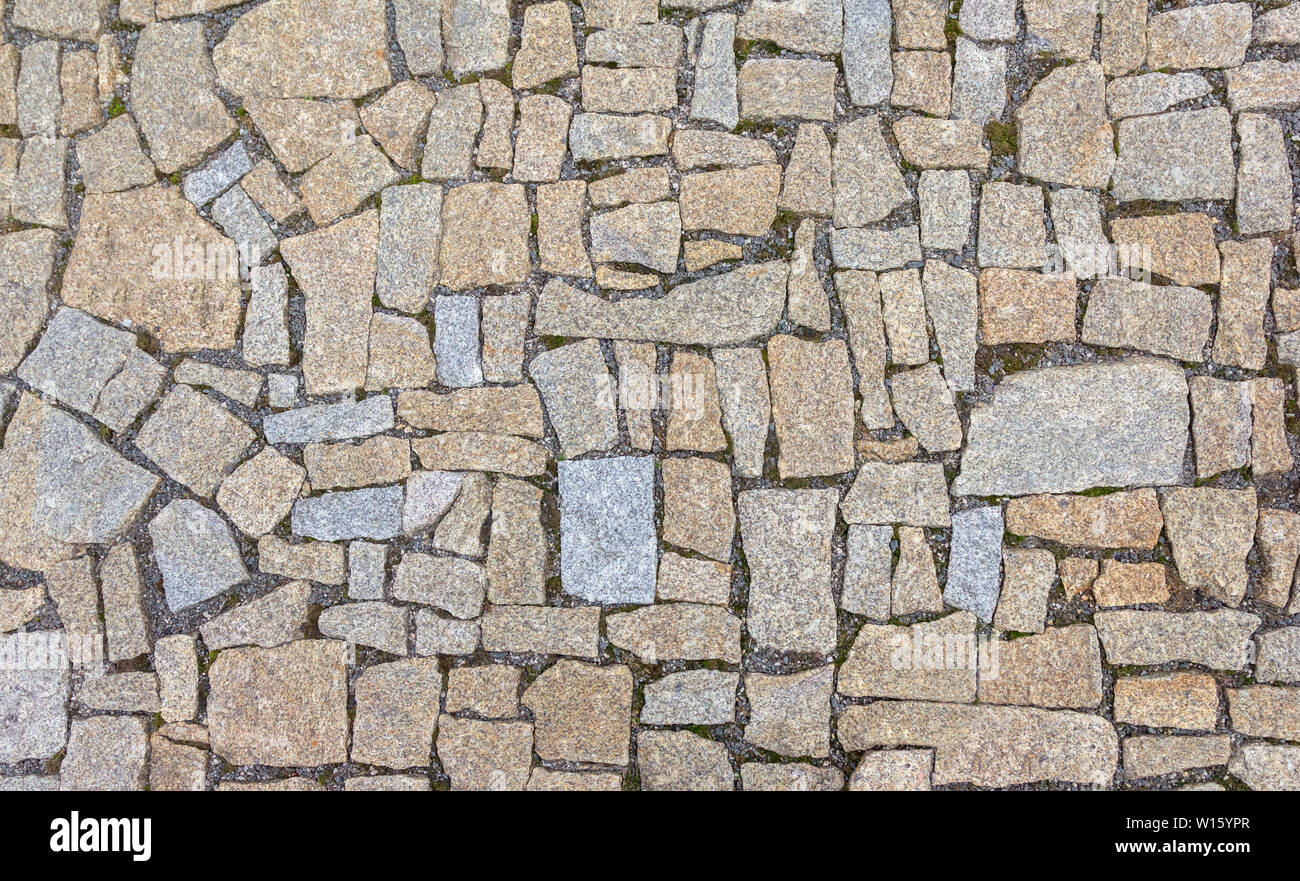 Old road paved with granite stones. Stock Photo