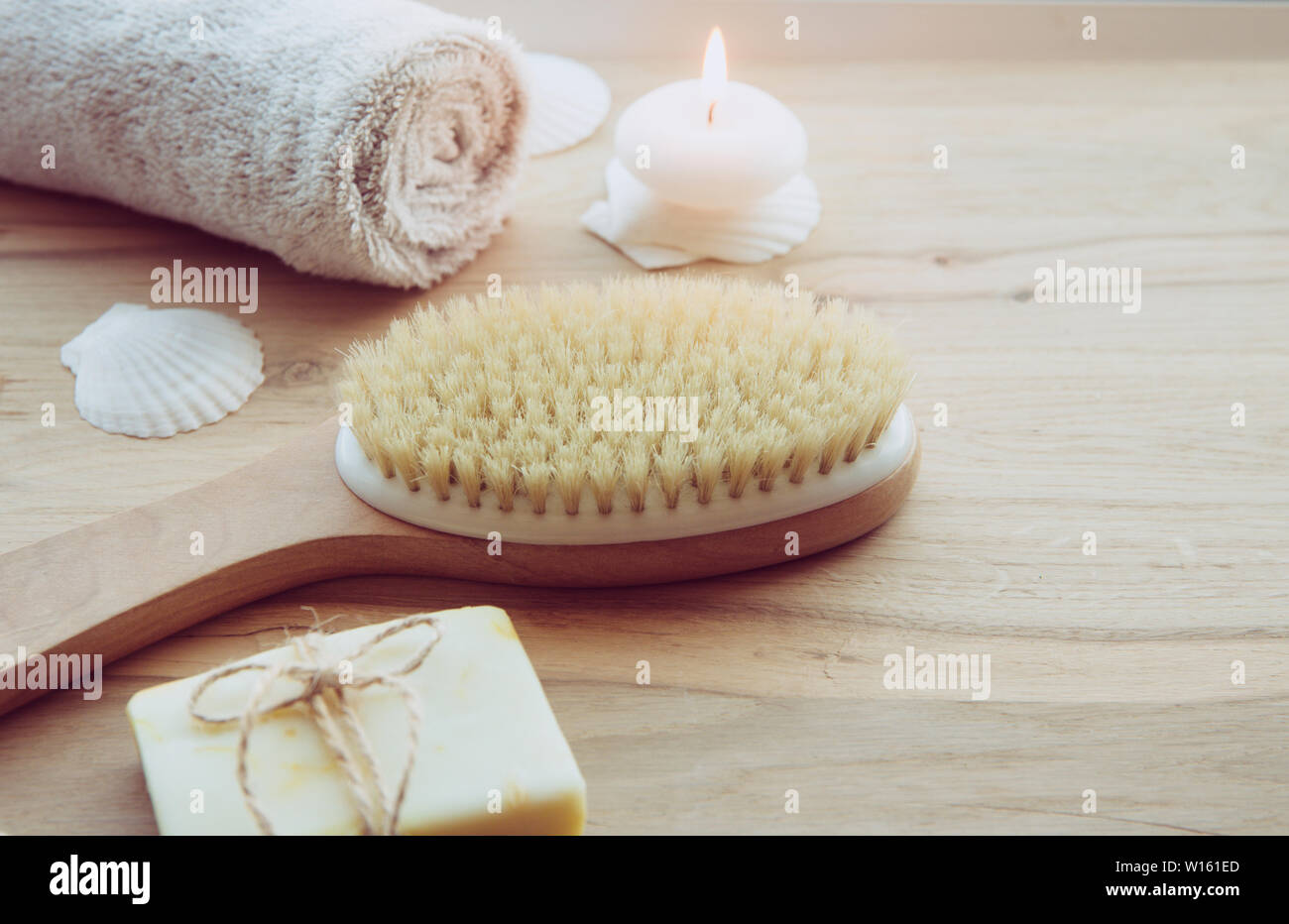 Dry brushing the skin in a pattern with a dry brush, usually before showering help reduce cellulite and remove toxins in human body. Selective focus o Stock Photo