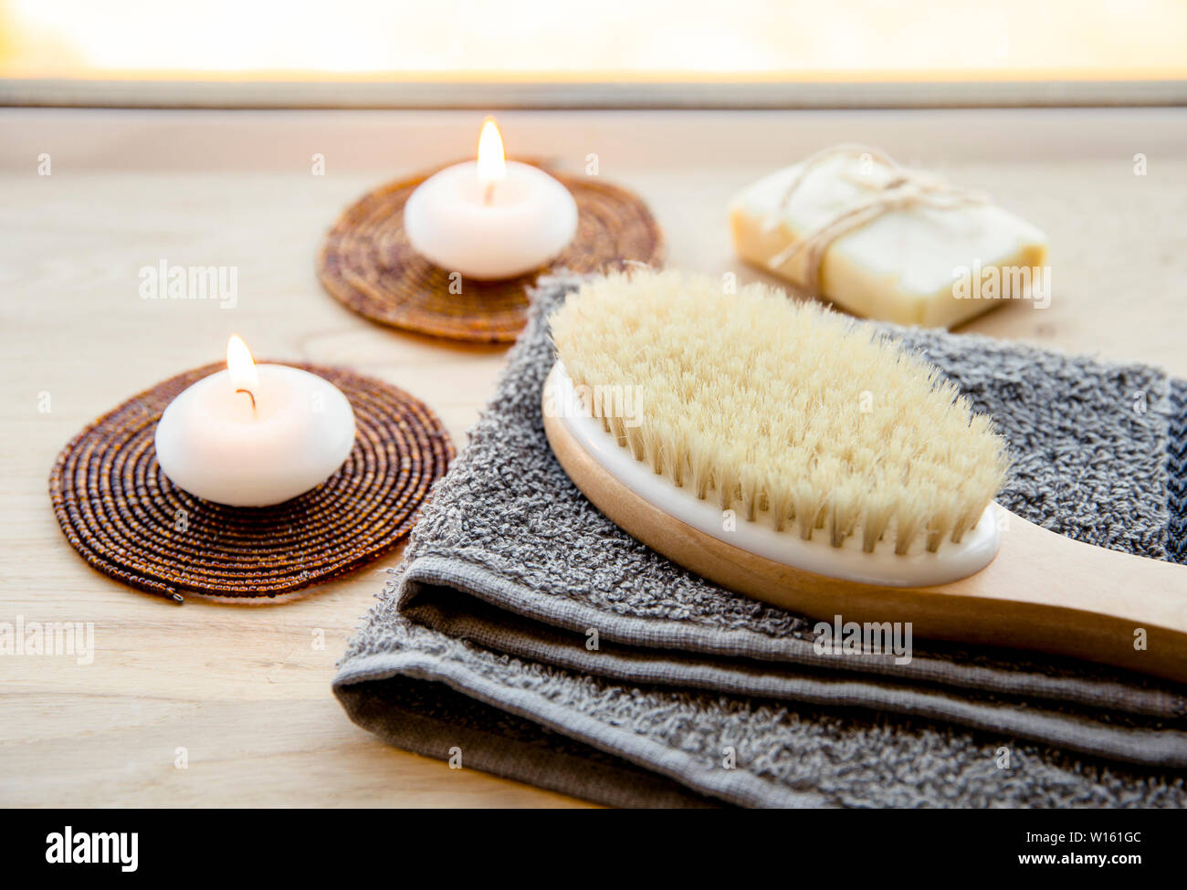 Dry brushing the skin in a pattern with a dry brush, usually before showering help reduce cellulite and remove toxins in human body. Selective focus n Stock Photo