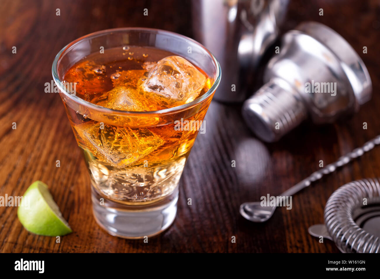 A delicious dark and stormy cocktail made with ginger beer, dark rum and lime. Stock Photo