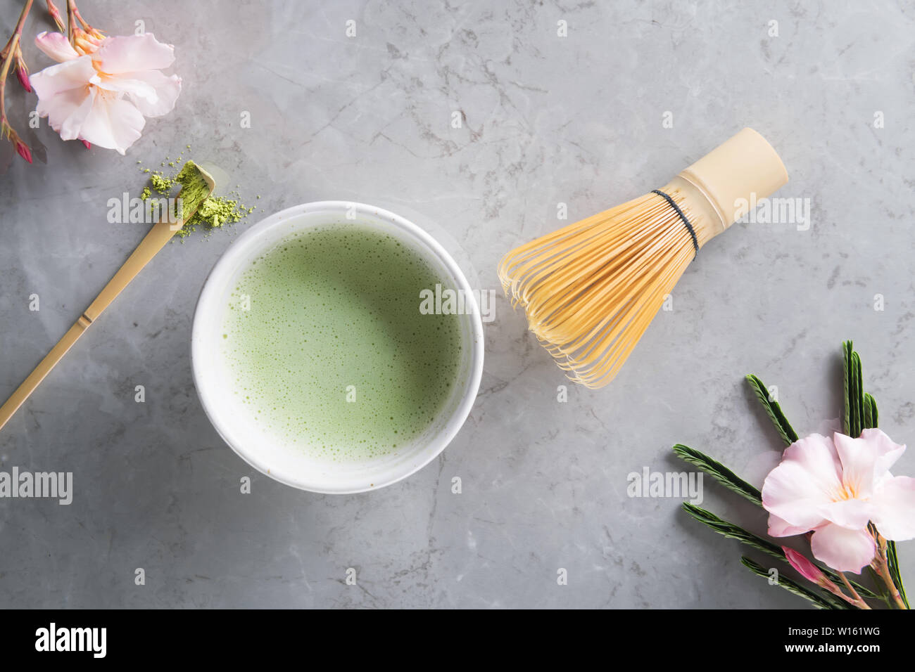 https://c8.alamy.com/comp/W161WG/top-view-of-green-tea-matcha-latte-with-bamboo-chasen-in-a-bowl-on-gray-marble-with-beautiful-oleander-flowers-japanese-tea-ceremony-concept-copy-sp-W161WG.jpg