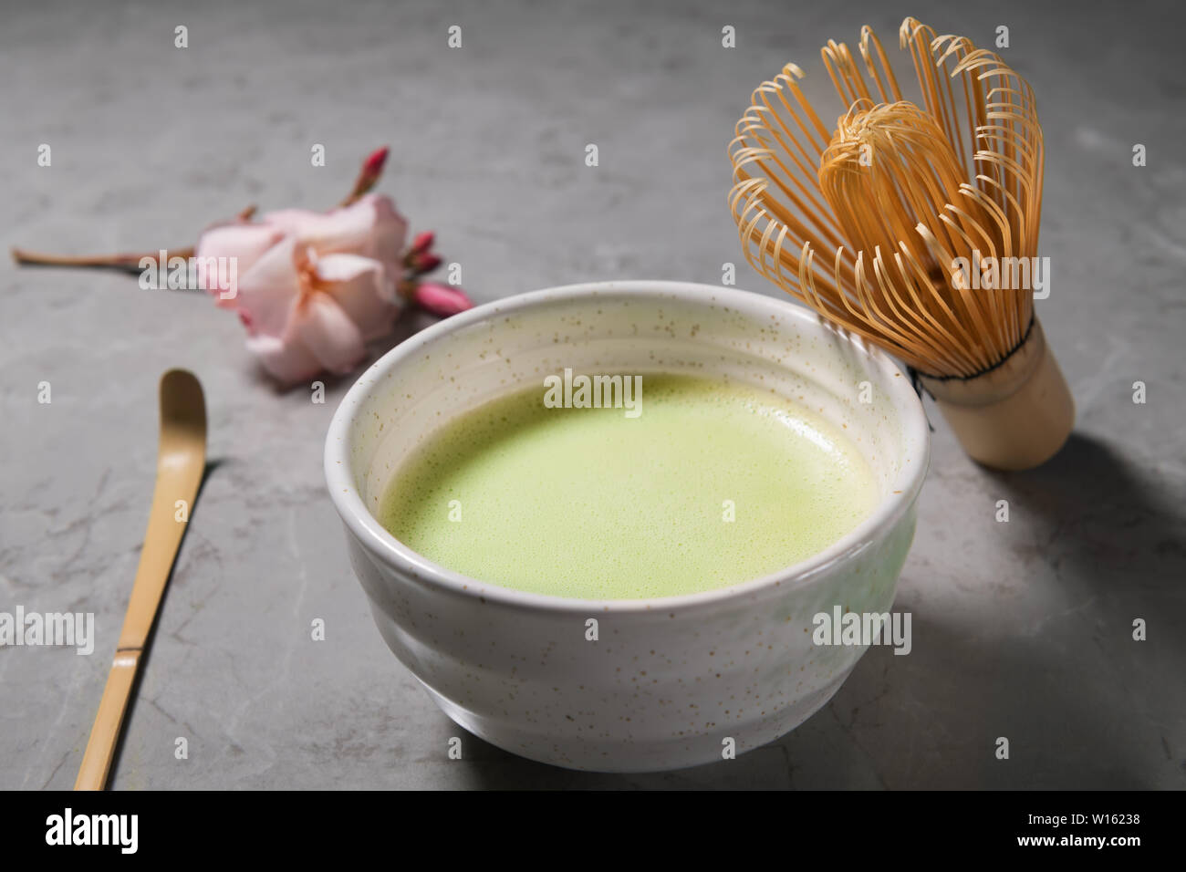 Ogranic green matcha tea drink and tea accessories - bamboo chesen on grey marble background. Japanese tea ceremony concept, close up Stock Photo