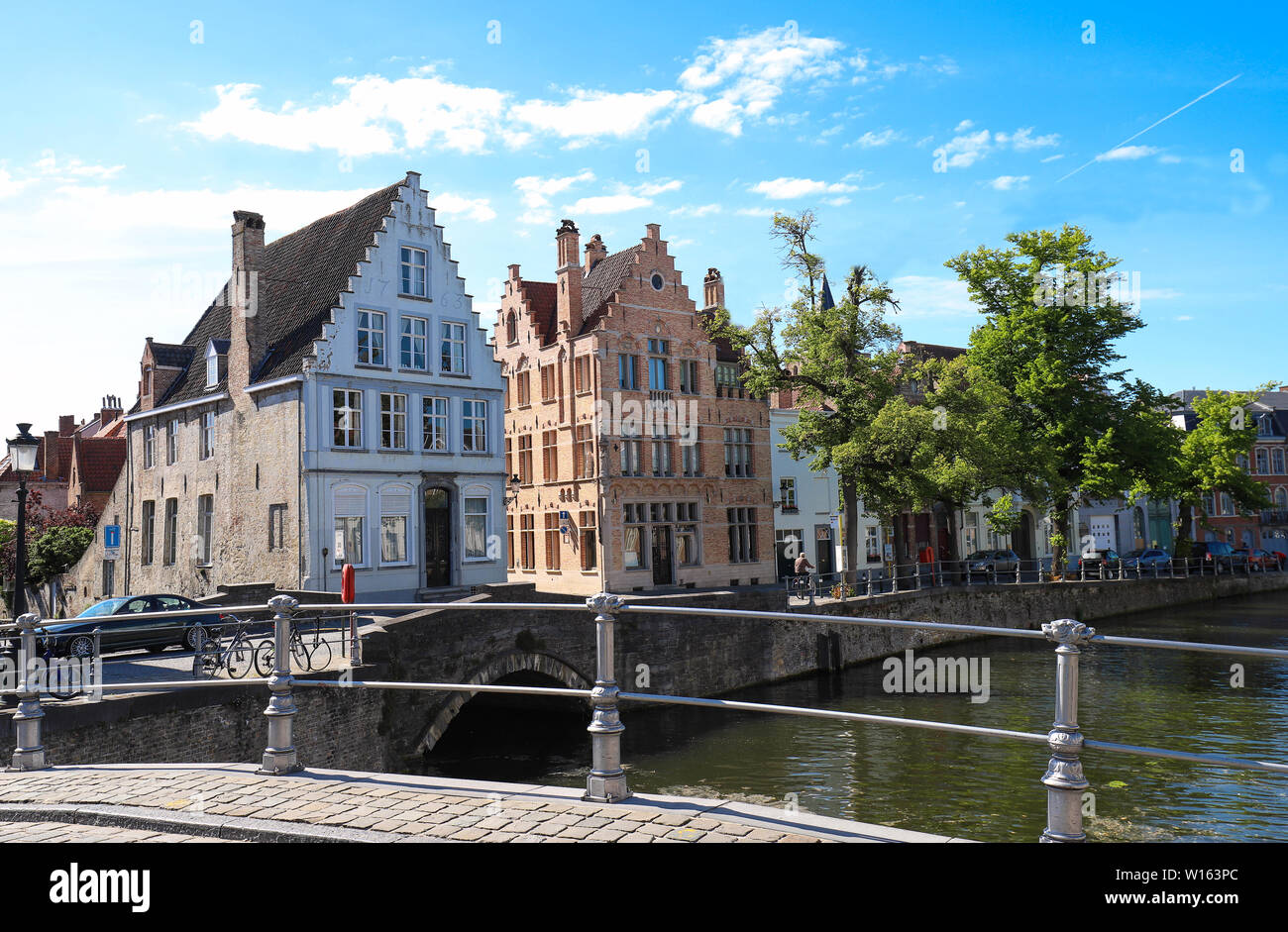 Scenic city view of Bruges canal with beautiful medieval colored houses and reflections. Stock Photo