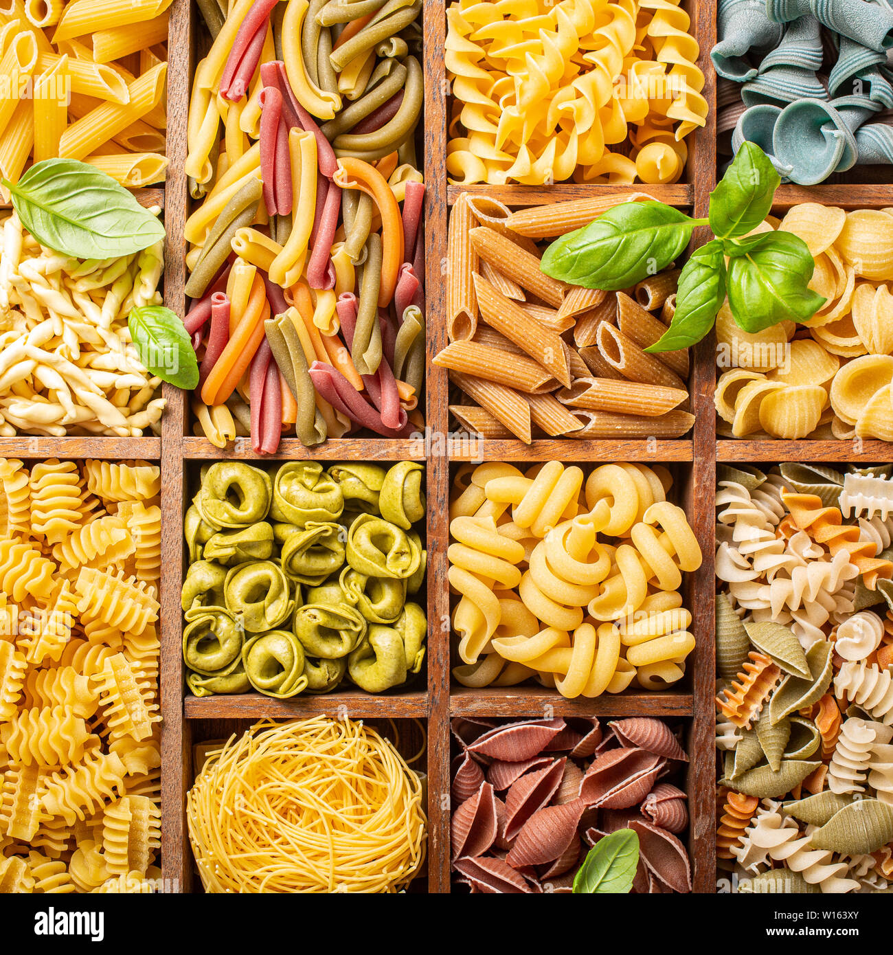 Assorted colorful italian pasta in wooden box Stock Photo - Alamy