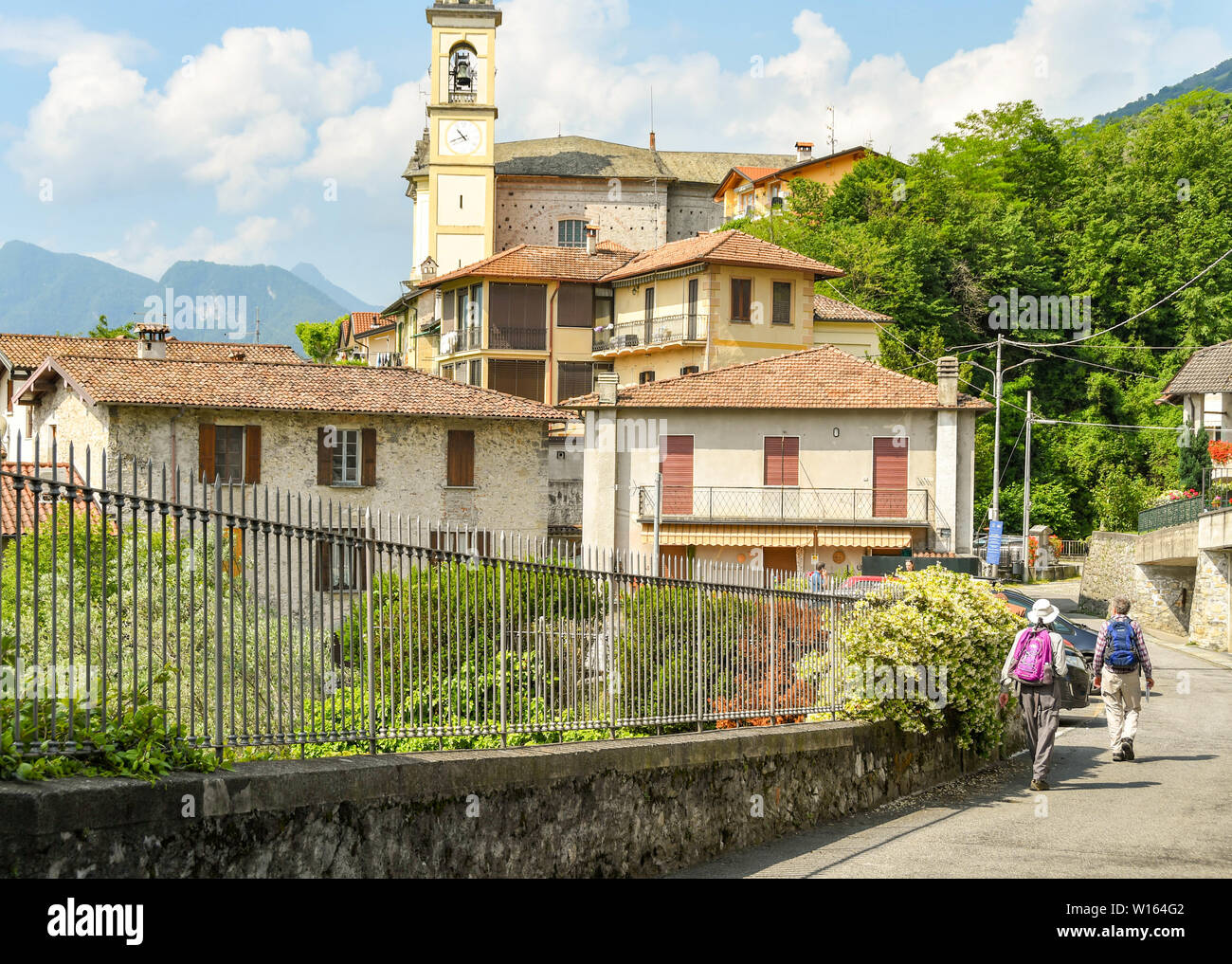 LAKE COMO, ITALY - JUNE 2019: People walking on the trail which runs for several miles around Lake Como - the Greenway del Lago di Como. Stock Photo