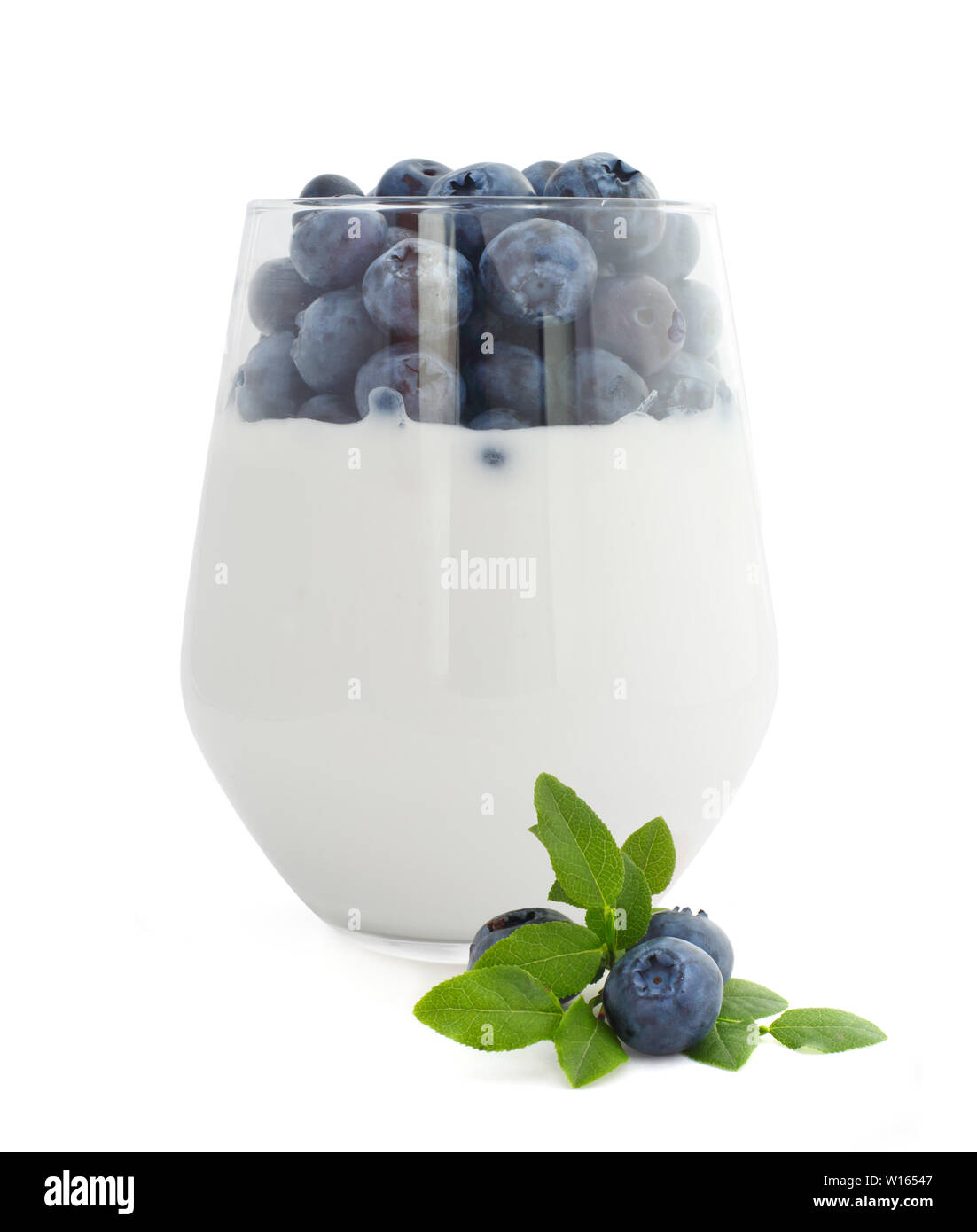 Yogurt and fresh berries blueberries studio isolated on white background Stock Photo
