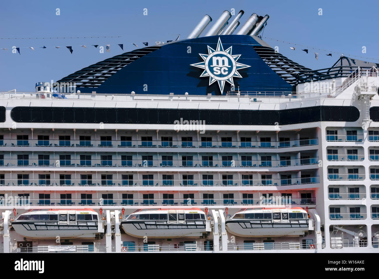 MSC Musica cruise ship, detail, close up. Summer vacations. Ship transport. Sunny day, clear blue sky. Stock Photo