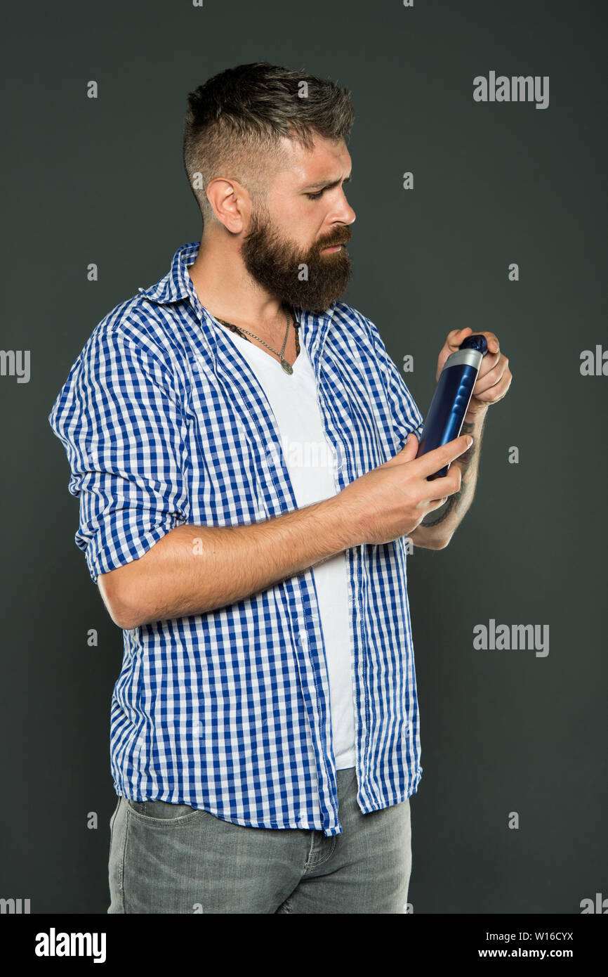 The Best Shampoo For His Hair Bearded Man Holding Shampoo Bottle
